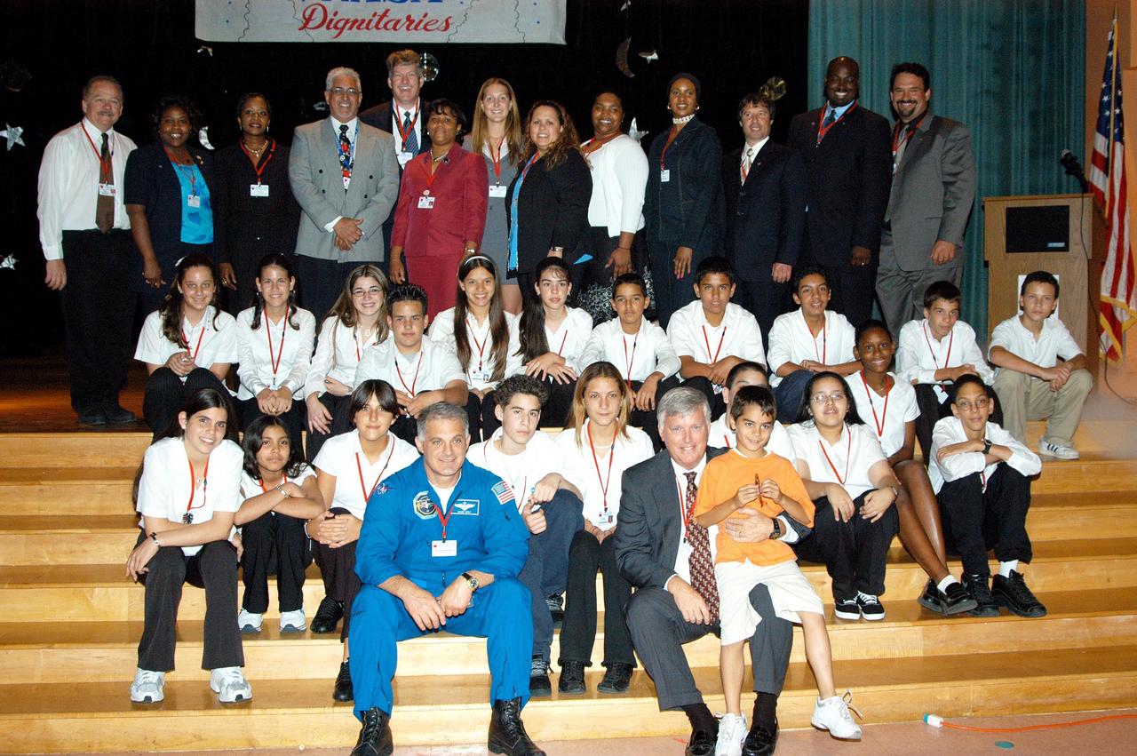 KENNEDY SPACE CENTER, FLA. -- Astronaut David Wolf (left) and Center Director Jim Kennedy (right, with boy) pose for a photo with students and faculty in Howard A. Doolin Middle School, Miami, Fla., plus other NASA and KSC representatives (rear). The school is one of 100 taking part in the NASA Explorer Schools (NES) program. The purpose of Kennedy’s visit is to share America’s new vision for space exploration with the next generation of explorers. He is talking with students in Florida and Georgia Explorer Schools about our destiny as explorers, NASA’s stepping stone approach to exploring Earth, the Moon, Mars and beyond, how space impacts our lives, and how people and machines rely on each other in space.