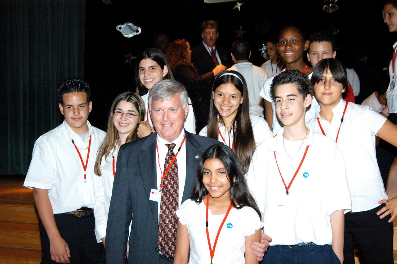 KENNEDY SPACE CENTER, FLA. -- Center Director Jim Kennedy poses for a photo with students at Howard A. Doolin Middle School, Miami, Fla. The school is one of 100 taking part in the NASA Explorer Schools (NES) program. The purpose of Kennedy’s visit is to share America’s new vision for space exploration with the next generation of explorers. He is talking with students in Florida and Georgia Explorer Schools about our destiny as explorers, NASA’s stepping stone approach to exploring Earth, the Moon, Mars and beyond, how space impacts our lives, and how people and machines rely on each other in space.