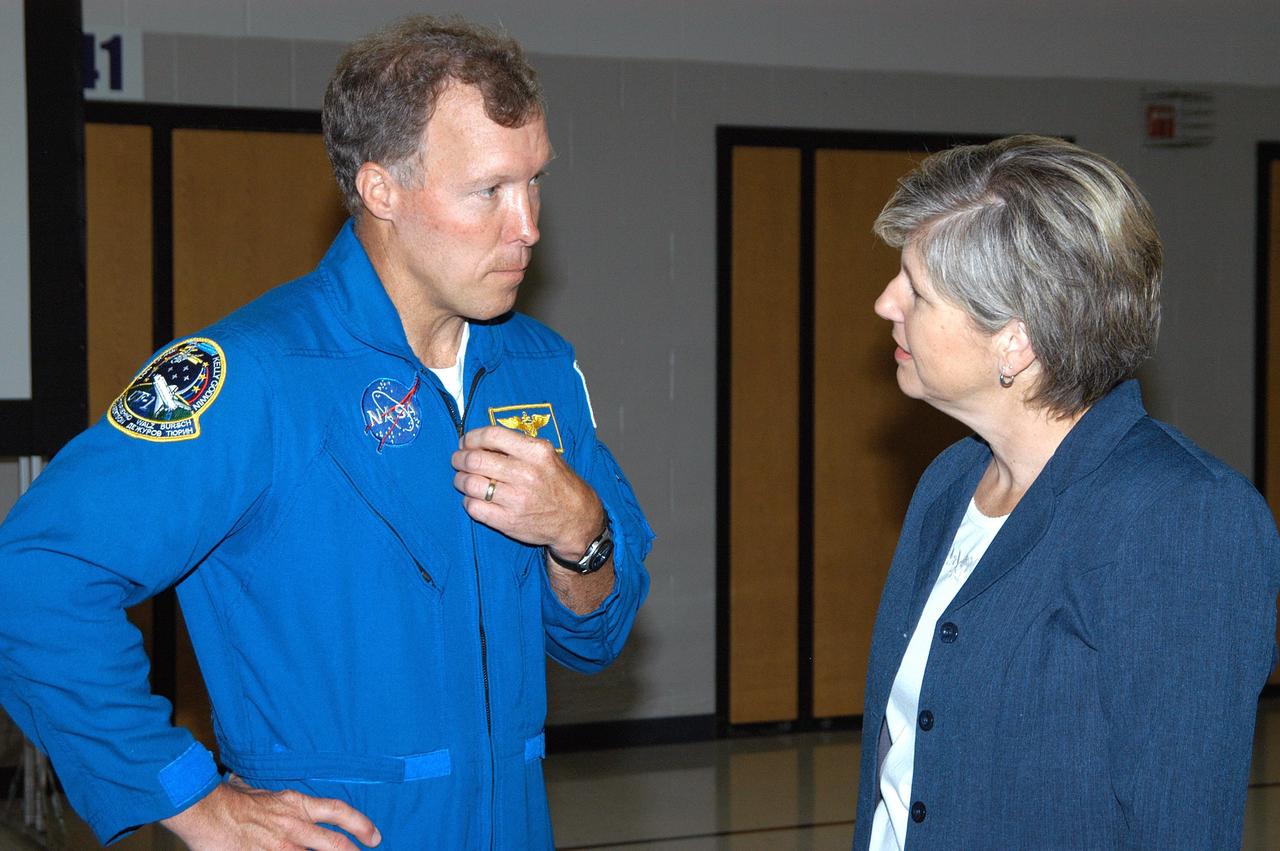 KENNEDY SPACE CENTER, FLA. -- Astronaut Dom Gorie (left) talks with a faculty member during a visit to Trojan Intermediate School in Potosi, Mo.  Students from three area schools — Potosi High School, John Evans Middle School and Trojan — are on a team taking part in NASA’s Explorer Schools program.  Gorie accompanied KSC Deputy Director Dr. Woodrow Whitlow on a visit to the school to share America’s new vision for space exploration with the next generation of explorers. Whitlow and Gorie are talking with students about our destiny as explorers, NASA’s stepping stone approach to exploring Earth, the Moon, Mars and beyond, how space impacts our lives, and how people and machines rely on each other in space.