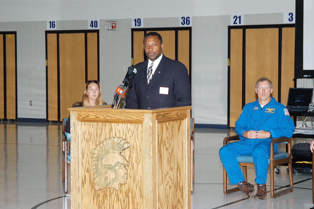 KENNEDY SPACE CENTER, FLA. -- At the podium, KSC Deputy Director Dr. Woodrow Whitlow talks to students in the gymnasium at Trojan Intermediate School in Potosi, Mo.  At left is Amber Marek, with the NASA News Center; at right is astronaut Dom Gorie.  Students from three area schools — Potosi High School, John Evans Middle School and Trojan —  are on a team taking part in NASA’s Explorer Schools program.  Whitlow and Gorie are visiting the school to share America’s new vision for space exploration with the next generation of explorers. They are talking with students about our destiny as explorers, NASA’s stepping stone approach to exploring Earth, the Moon, Mars and beyond, how space impacts our lives, and how people and machines rely on each other in space.