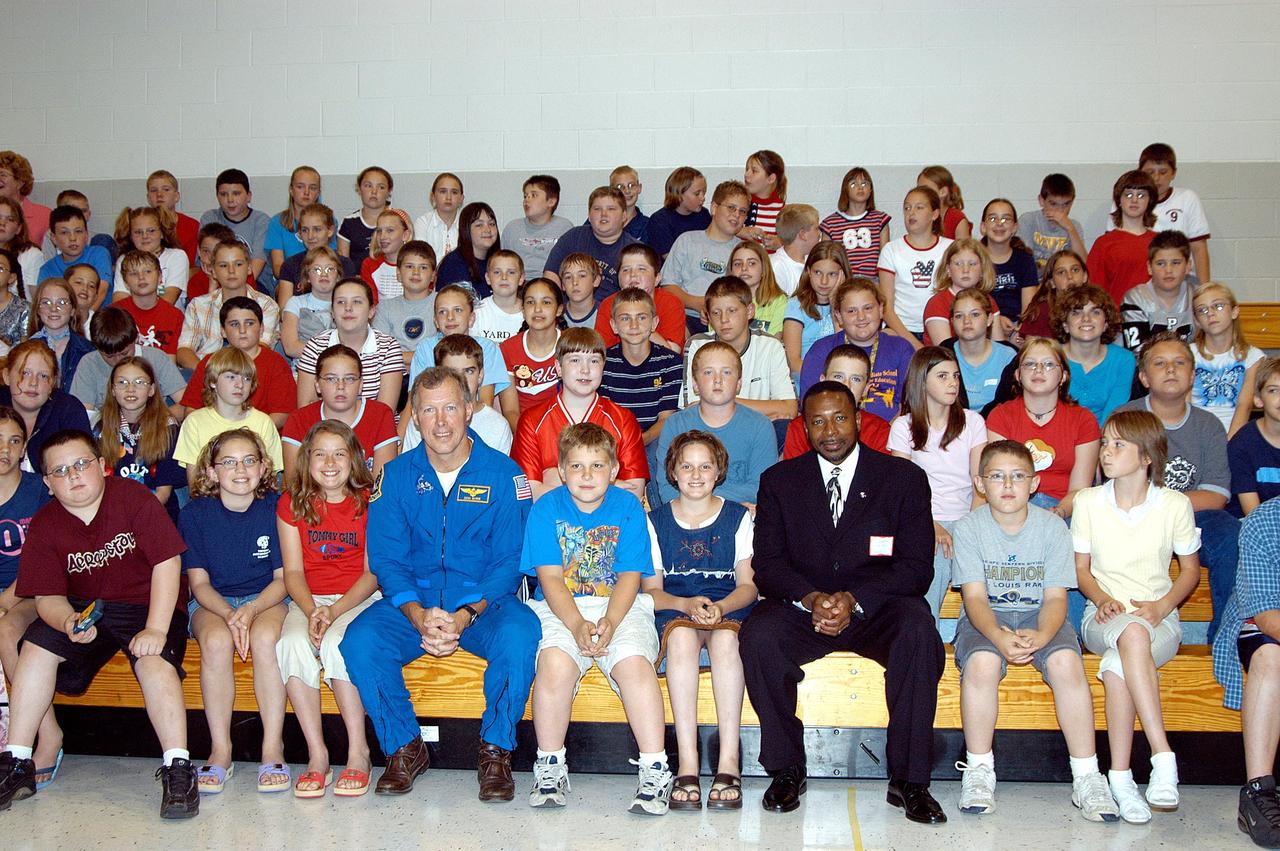 KENNEDY SPACE CENTER, FLA. -- Astronaut Dom Gorie (left) and KSC Deputy Director Dr. Woodrow Whitlow (right) join students in the gymnasium stands at Trojan Intermediate School in Potosi, Mo. Students from three area schools — Potosi High School, John Evans Middle School and Trojan — are on a team taking part in NASA’s Explorer Schools program.  Whitlow and astronaut Dom Gorie are sharing America’s new vision for space exploration with the next generation of explorers. They are talking with students about our destiny as explorers, NASA’s stepping stone approach to exploring Earth, the Moon, Mars and beyond, how space impacts our lives, and how people and machines rely on each other in space.