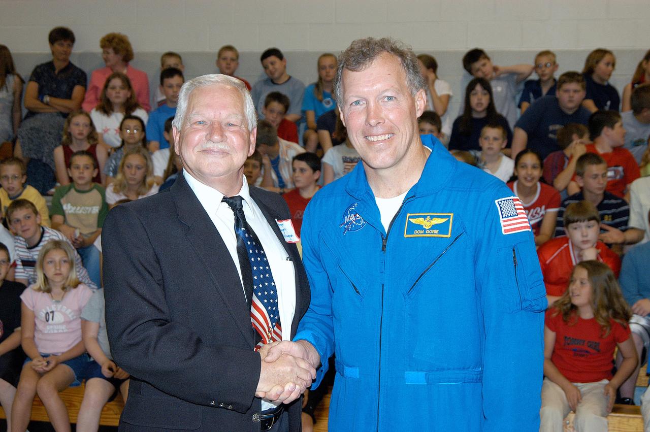 KENNEDY SPACE CENTER, FLA. -- Mayor Wayne Malugen of Potosi, Mo., poses with astronaut Dom Gorie after a presentation by KSC Deputy Director Dr. Woodrow Whitlow and Gorie to students and faculty at Trojan Intermediate School.  Whitlow and Gorie are sharing America’s new vision for space exploration with the next generation of explorers. They are talking with students about our destiny as explorers, NASA’s stepping stone approach to exploring Earth, the Moon, Mars and beyond, how space impacts our lives, and how people and machines rely on each other in space.  Students from three area schools — Potosi High School, John Evans Middle School and Trojan — are on a team taking part in NASA’s Explorer Schools program.