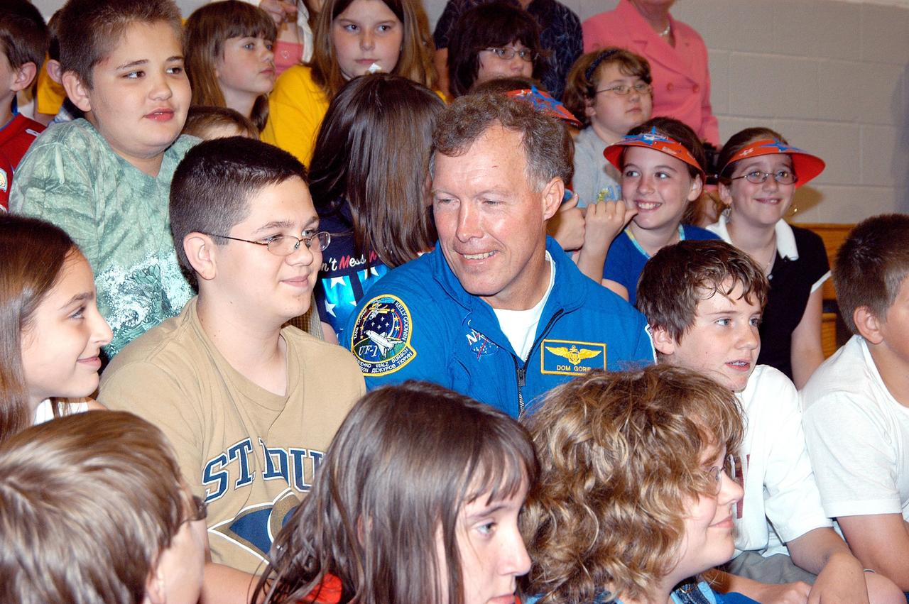 KENNEDY SPACE CENTER, FLA. -- Astronaut Dom Gorie sits in the gymnasium stands with students at Trojan Intermediate School in Potosi, Mo.  Gorie accompanied KSC Deputy Director Dr. Woodrow Whitlow on a visit to the school to share America’s new vision for space exploration with the next generation of explorers. They are talking with students about our destiny as explorers, NASA’s stepping stone approach to exploring Earth, the Moon, Mars and beyond, how space impacts our lives, and how people and machines rely on each other in space.  Students from three area schools — Potosi High School, John Evans Middle School and Trojan — are on a team taking part in NASA’s Explorer Schools program.