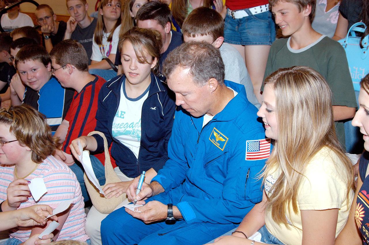 KENNEDY SPACE CENTER, FLA. -- Astronaut Dom Gorie signs autographs for students at Trojan Intermediate School in Potosi, Mo.  Gorie accompanied KSC Deputy Director Dr. Woodrow Whitlow on a visit to the school to share America’s new vision for space exploration with the next generation of explorers. They are talking with students about our destiny as explorers, NASA’s stepping stone approach to exploring Earth, the Moon, Mars and beyond, how space impacts our lives, and how people and machines rely on each other in space.  Students from three area schools — Potosi High School, John Evans Middle School and Trojan — are on a team taking part in NASA’s Explorer Schools program.