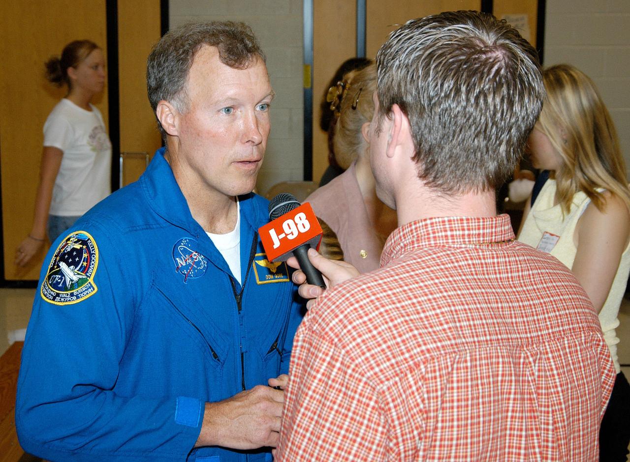 KENNEDY SPACE CENTER, FLA. -- A reporter from KJFF radio interviews astronaut Dom Gorie after his presentation at Trojan Intermediate School in Potosi, Mo.  Students from three area schools — Potosi High School, John Evans Middle School and Trojan — are on a team taking part in NASA’s Explorer Schools program.  KSC Deputy Director Dr. Woodrow Whitlow and Gore are sharing America’s new vision for space exploration with the next generation of explorers. They are talking with students about our destiny as explorers, NASA’s stepping stone approach to exploring Earth, the Moon, Mars and beyond, how space impacts our lives, and how people and machines rely on each other in space.
