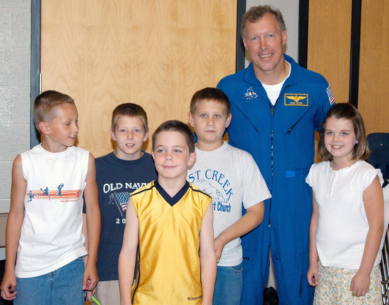 KENNEDY SPACE CENTER, FLA. -- Astronaut Dom Gorie joins students at Trojan Intermediate School in Potosi, Mo., for a group photo.  Students from three area schools — Potosi High School, John Evans Middle School and Trojan — are on a team taking part in NASA’s Explorer Schools program.   Gorie accompanied KSC Deputy Director Dr. Woodrow Whitlow on a visit to the school to share America’s new vision for space exploration with the next generation of explorers. They are talking with students about our destiny as explorers, NASA’s stepping stone approach to exploring Earth, the Moon, Mars and beyond, how space impacts our lives, and how people and machines rely on each other in space.