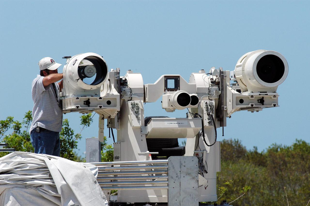KENNEDY SPACE CENTER, FLA. -- Johnson Controls operator Kenny Allen works on the recently acquired Contraves-Goerz Kineto Tracking Mount (KTM). Trailer-mounted with a center console/seat and electric drive tracking mount, the KTM includes a two-camera, camera control unit that will be used during launches. The KTM is designed for remotely controlled operations and offers a combination of film, shuttered and high-speed digital video, and FLIR cameras configured with 20-inch to 150-inch focal length lenses. The KTMs are generally placed in the field and checked out the day before a launch and manned 3 hours prior to liftoff. There are 10 KTMs certified for use on the Eastern Range.