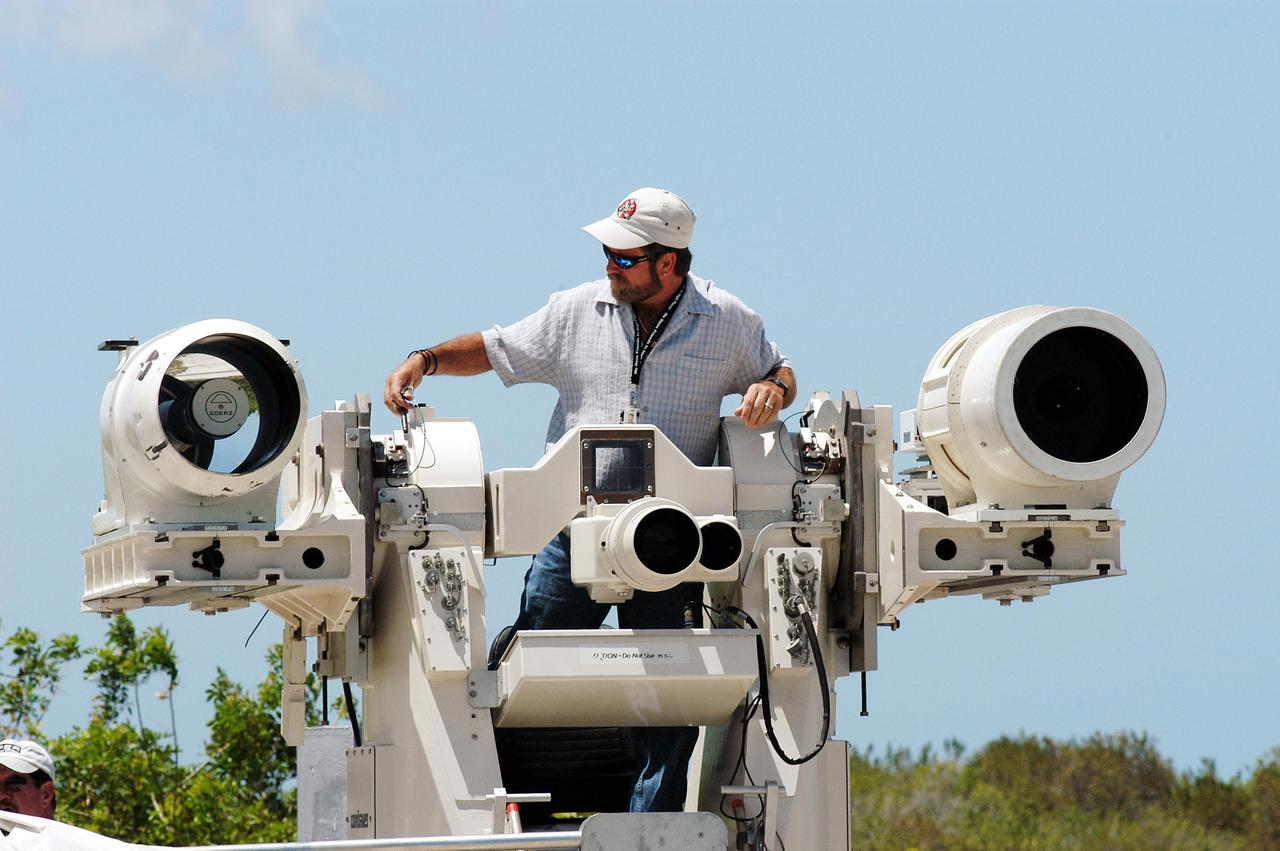 KENNEDY SPACE CENTER, FLA. -- Johnson Controls operator Kenny Allen works on the recently acquired Contraves-Goerz Kineto Tracking Mount (KTM). Trailer-mounted with a center console/seat and electric drive tracking mount, the KTM includes a two-camera, camera control unit that will be used during launches. The KTM is designed for remotely controlled operations and offers a combination of film, shuttered and high-speed digital video, and FLIR cameras configured with 20-inch to 150-inch focal length lenses. The KTMs are generally placed in the field and checked out the day before a launch and manned 3 hours prior to liftoff. There are 10 KTMs certified for use on the Eastern Range.