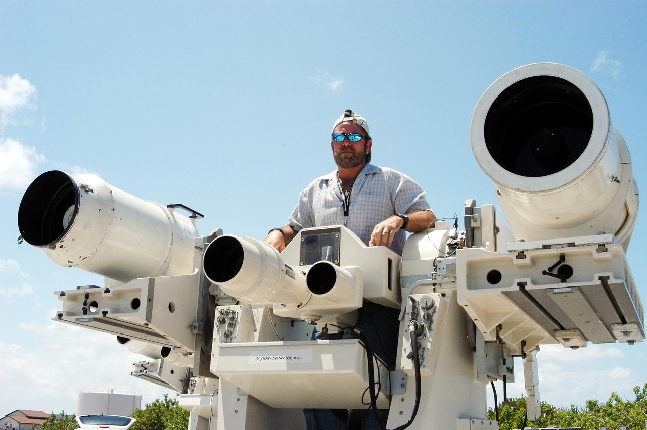 KENNEDY SPACE CENTER, FLA. -- Johnson Controls operator Kenny Allen stands in the center console area of one of the recently acquired Contraves-Goerz Kineto Tracking Mounts (KTM). There are 10 KTMs certified for use on the Eastern Range. The KTM, which is trailer-mounted with an electric-drive tracking mount, includes a two-camera, camera control unit that will be used during launches. The KTM is designed for remotely controlled operations and offers a combination of film, shuttered and high-speed digital video, and FLIR cameras configured with 20-inch to 150-inch focal length lenses. The KTMs are generally placed in the field and checked out the day before a launch and manned 3 hours prior to liftoff.