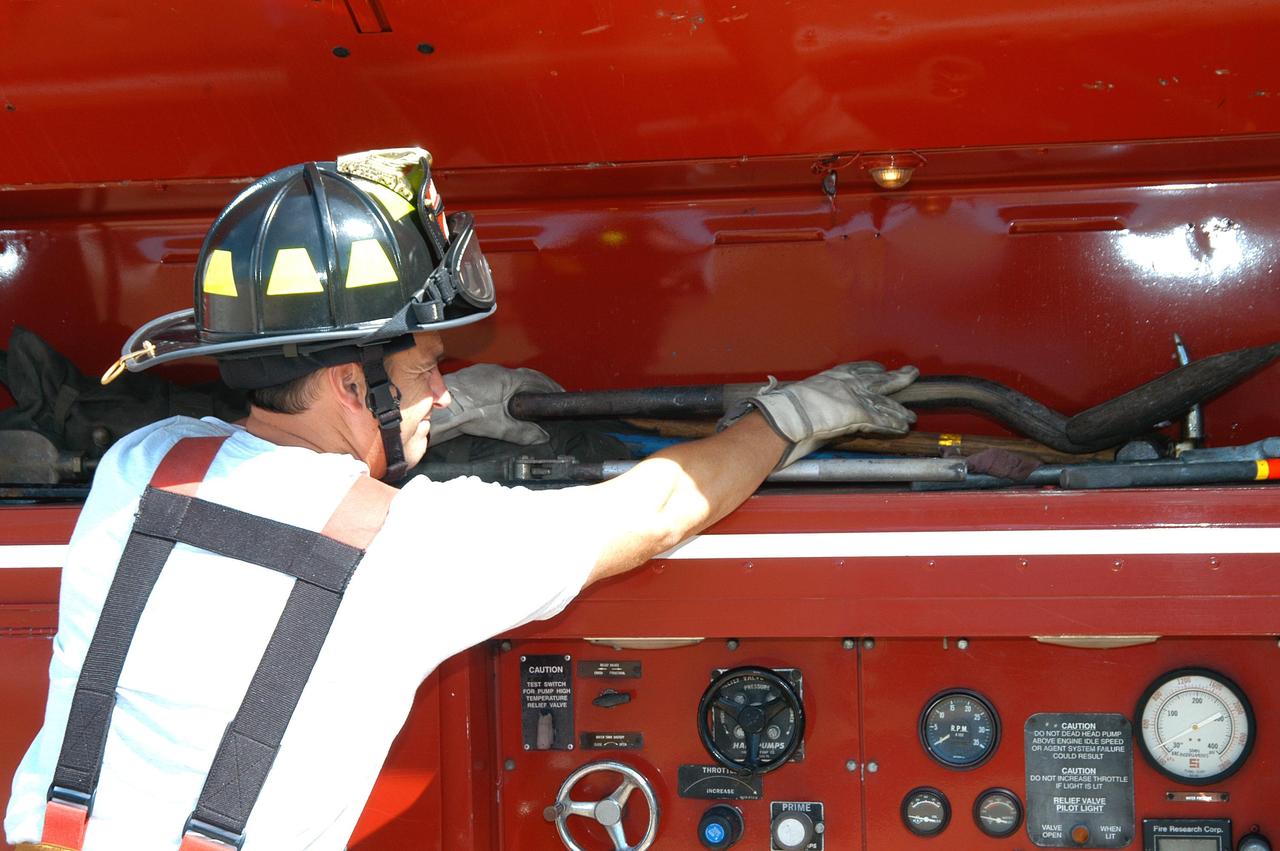 KENNEDY SPACE CENTER, FLA.  -  At Cape Canaveral Air Force Station, KSC Firefighter Chris Maupin puts away a piece of equipment.  He and other KSC firefighters teamed up with task forces from Satellite Beach, Malabar, Melbourne, Palm Bay, Patrick Air Force Base and Brevard County to help fight wildfires in the Palm Bay and Malabar areas that threatened homes and property during the Memorial Day holiday weekend.