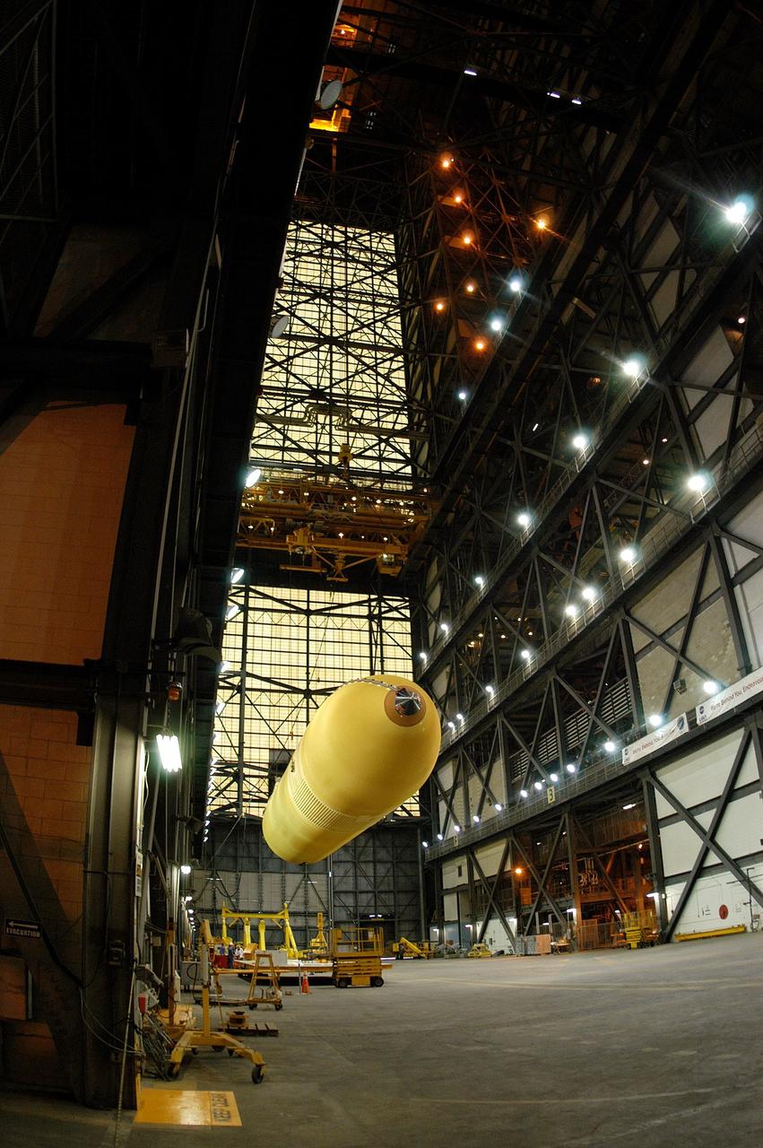 KENNEDY SPACE CENTER, FLA.  -  An external tank is lowered into a horizontal position in the transfer aisle of the Vehicle Assembly Building before being placed on a transporter.  The tank is being transferred to the Michoud Space Systems Assembly Facility near New Orleans where redesign of the external tank is underway for Return to Flight.