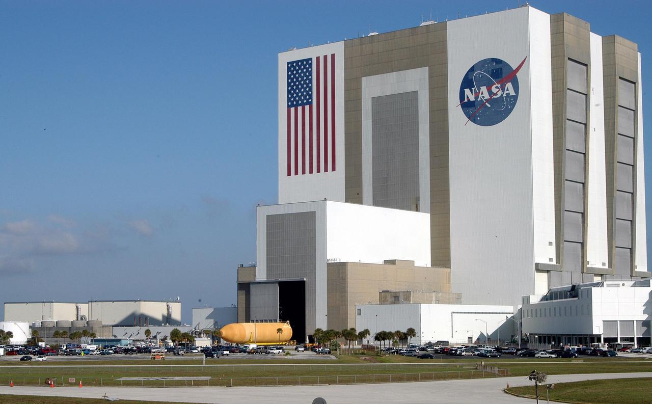 KENNEDY SPACE CENTER, FLA.  -  -   The external tank seen here exits the Vehicle Assembly Building via transporter.  The tank is being transferred to the Michoud Space Systems Assembly Facility near New Orleans where redesign of the external tank is underway for Return to Flight.