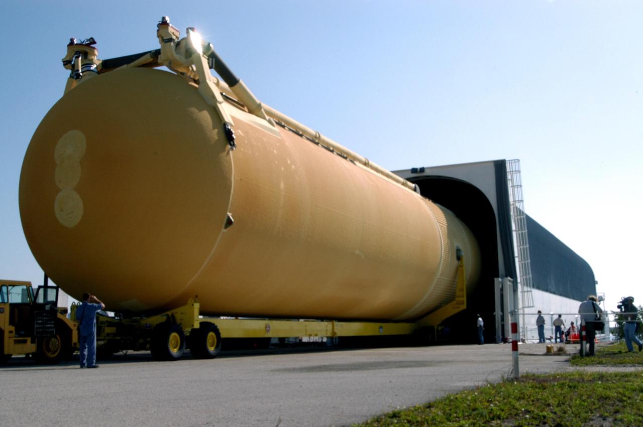 KENNEDY SPACE CENTER, FLA.  - After leaving the Vehicle Assembly Building, the external tank moves into the barge at the Turn Basin on Launch Complex Area 39.  Once loaded, the barge will deliver it to the Michoud Space Systems Assembly Facility near New Orleans where redesign of the external tank is underway for Return to Flight.