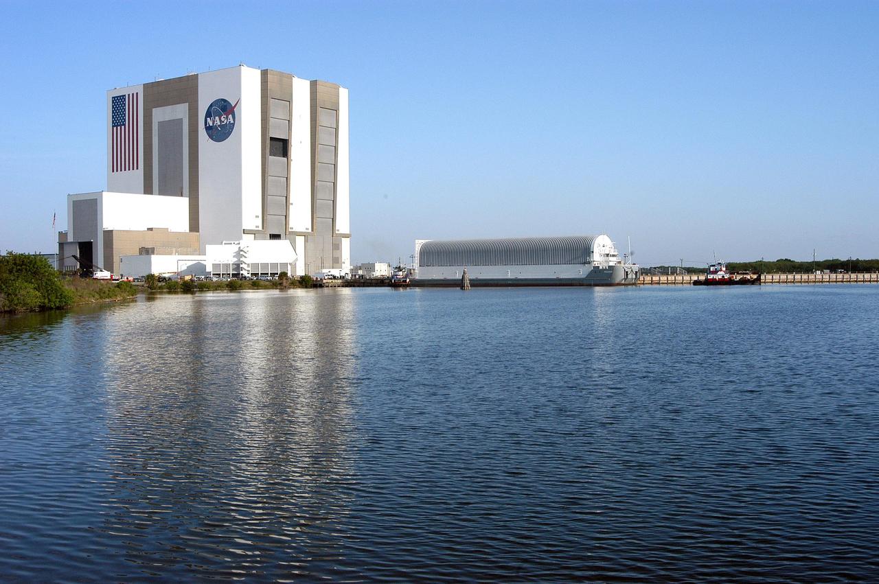 KENNEDY SPACE CENTER, FLA.  - Viewed across the turn basin in the Launch Complex 39 Area at KSC, the barge containing an External Tank (ET) waits to be towed to Port Canaveral. There one of the SRB Retrieval Ships will take over and tow the ET to the Michoud Space Systems Assembly Facility near New Orleans where redesign of the external tank is underway for Return to Flight.