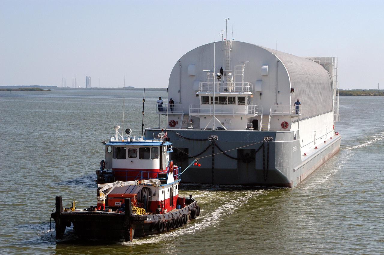 KENNEDY SPACE CENTER, FLA.  - A tug boat tows the barge containing an External Tank (ET) to Port Canaveral. There one of the SRB Retrieval Ships will take over and tow the ET to the Michoud Space Systems Assembly Facility near New Orleans where redesign of the external tank is underway for Return to Flight.