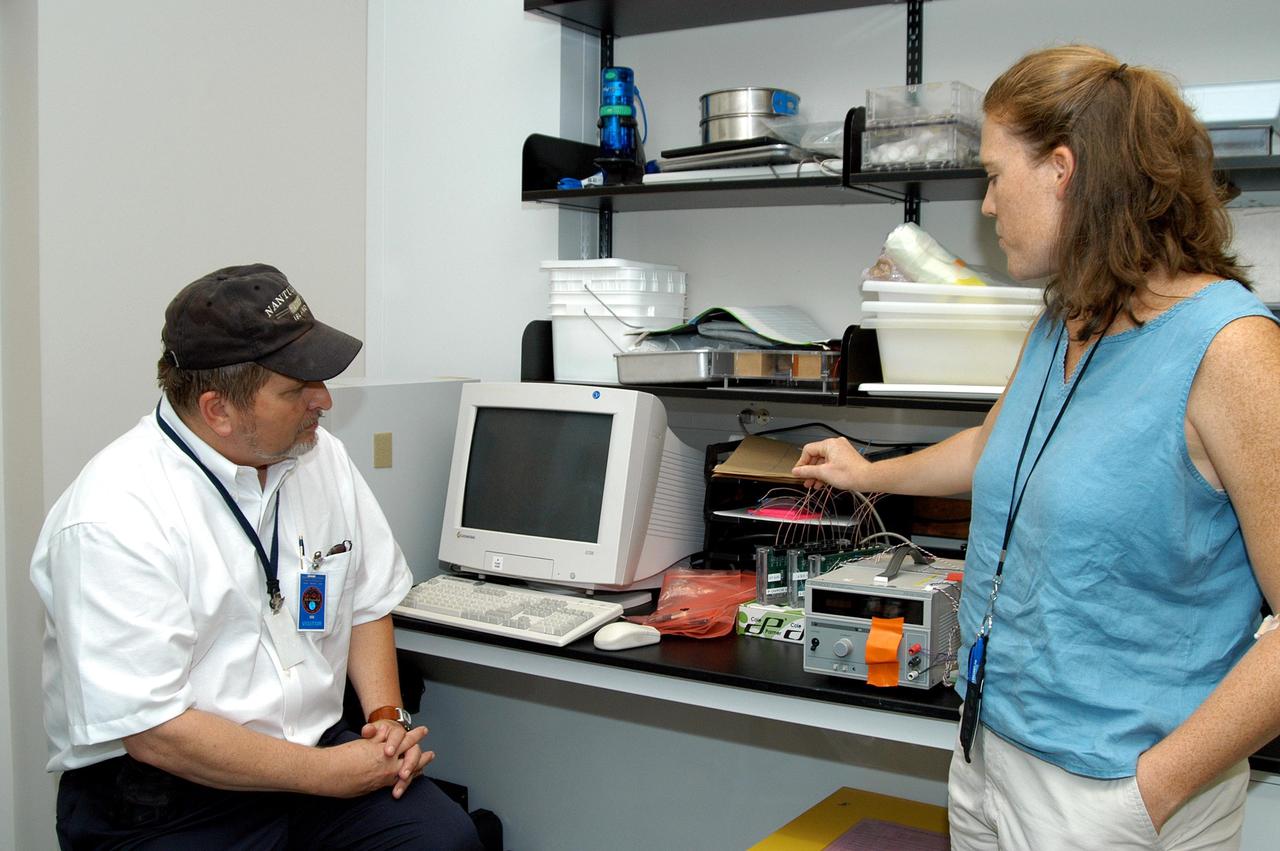 KENNEDY SPACE CENTER, FLA. - Paul Curto (left), chief technologist with NASA’s Inventions and Contributions Board, learns about research being done in the Space Life Sciences Lab from Jessica Prenger, senior agricultural engineer. Curto is visiting KSC to talk to innovators and encourage workers to submit technologies for future Space Act Awards. The Inventions and Contributions Board, established in 1958, is a major contributor in rewarding outstanding scientific or technical contributions sponsored, adopted, supported or used by NASA that are significant to aeronautics and space activities.