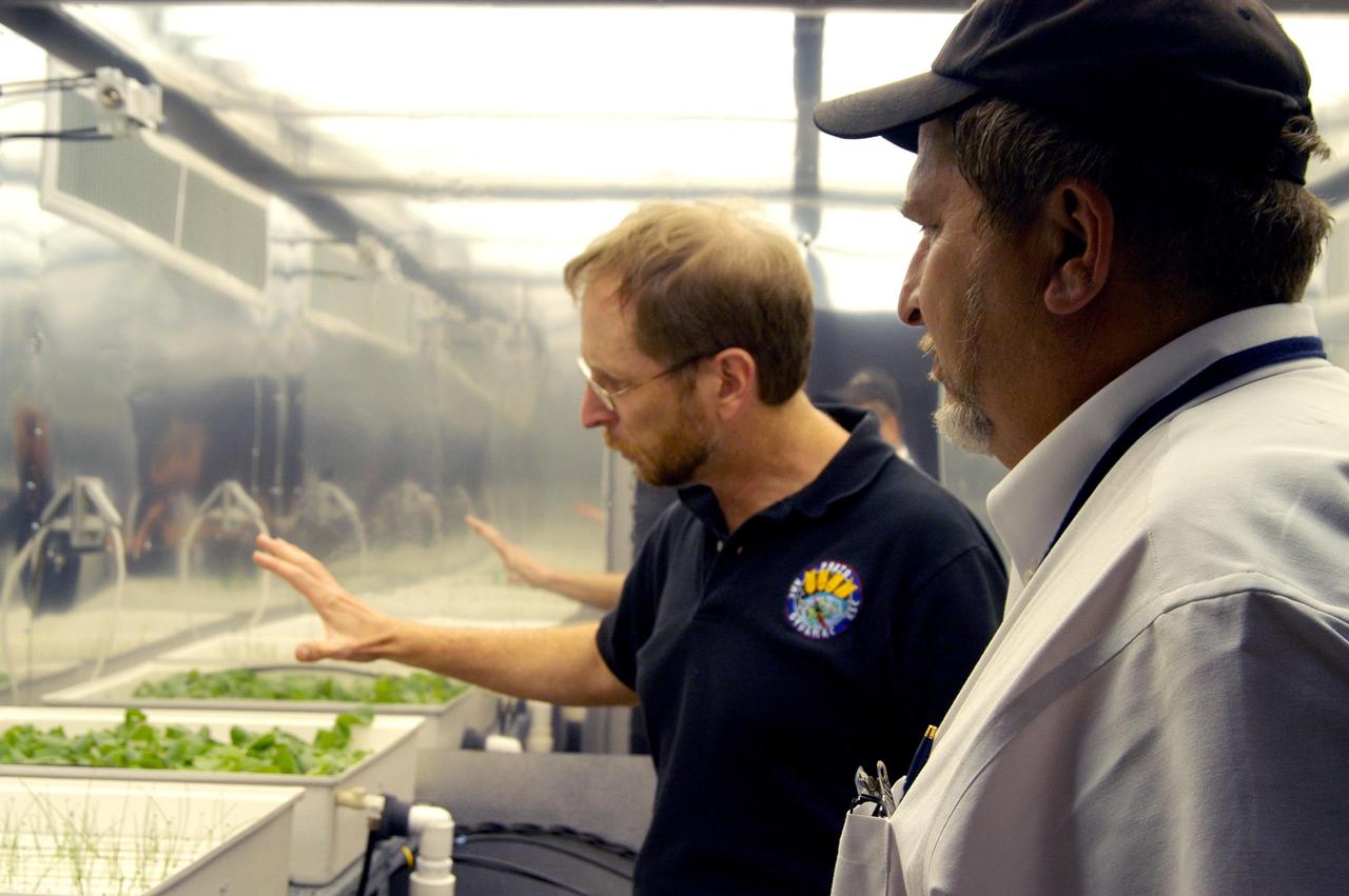 KENNEDY SPACE CENTER, FLA. - Dr. Gary Stutte explains to Paul Curto (right), chief technologist with NASA’s Inventions and Contributions Board, the research being done in this plant growth chamber in the Space Life Sciences Lab. Stutte is a senior research scientist with Dynamac Corp. Curto is visiting KSC to talk to innovators and encourage workers to submit technologies for future Space Act Awards. The Inventions and Contributions Board, established in 1958, is a major contributor in rewarding outstanding scientific or technical contributions sponsored, adopted, supported or used by NASA that are significant to aeronautics and space activities.