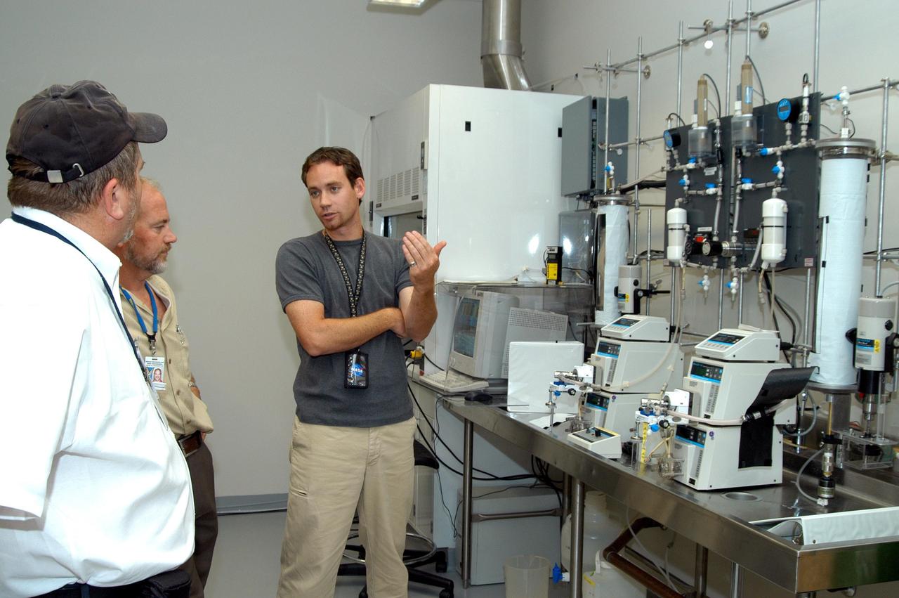 KENNEDY SPACE CENTER, FLA. - Paul Curto (left), chief technologist with NASA’s Inventions and Contributions Board, learns from bioengineer Tony Rector (right) about a wastewater processing project Rector is working on in the Space Life Sciences Lab. Curto is visiting KSC to talk to innovators and encourage workers to submit technologies for future Space Act Awards. The Inventions and Contributions Board, established in 1958, is a major contributor in rewarding outstanding scientific or technical contributions sponsored, adopted, supported or used by NASA that are significant to aeronautics and space activities.