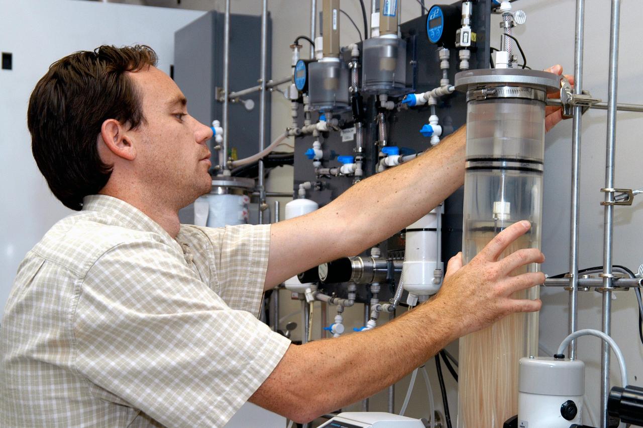 KENNEDY SPACE CENTER, FLA. - In the KSC Space Life Sciences Lab’s Resource Recovery lab, bioengineer Tony Rector checks the ARMS reactor vessel. ARMS, or Aerobic Rotational Membrane System, is a wastewater processing project being tested for use on the International Space Station to collect, clean and reuse wastewater. It could be adapted for use on the Moon and Mars. The Lab is exploring various aspects of a bioregenerative life support system. Such research and technology development will be crucial to long-term habitation of space by humans.