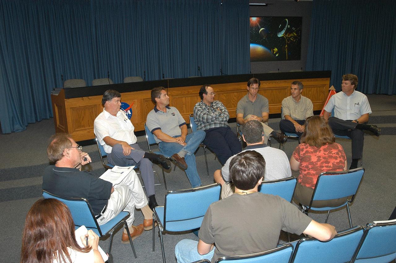 KENNEDY SPACE CENTER, FLA.  - Reporters (bottom) take notes during an informal briefing concerning NASA’s Cassini spacecraft, launched aboard an Air Force Titan IV rocket from Cape Canaveral Air Force Station Oct. 15, 1997.  Cassini launch team members seen here discussed the challenge and experience of preparing Cassini for launch, integrating it with the Titan IV rocket and the countdown events of launch day.  Facing the camera (from left) are Ron Gillett, NASA Safety and Lead Federal Agency official; Omar Baez, mechanical and propulsion systems engineer; Ray Lugo, NASA launch manager; Chuck Dovale, chief, Avionics Branch; George Haddad, Integration and Ground Systems mechanical engineer; and Ken Carr, Cassini assistant launch site support manager.  Approximately 10:36 p.m. EDT, June 30, the Cassini-Huygens spacecraft will arrive at Saturn. After nearly a seven-year journey, it will be the first mission to orbit Saturn. The international cooperative mission plans a four-year tour of Saturn, its rings, icy moons, magnetosphere, and Titan, the planet’s largest moon.