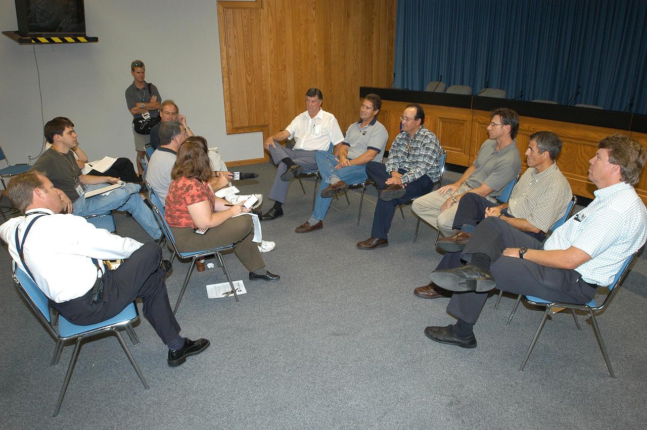 KENNEDY SPACE CENTER, FLA.  - Reporters (left) take notes during an informal briefing concerning NASA’s Cassini spacecraft, launched aboard an Air Force Titan IV rocket from Cape Canaveral Air Force Station Oct. 15, 1997.  Cassini launch team members at right discussed the challenge and experience of preparing Cassini for launch, integrating it with the Titan IV rocket and the countdown events of launch day.  From left are Ron Gillett, NASA Safety and Lead Federal Agency official; Omar Baez, mechanical and propulsion systems engineer; Ray Lugo, NASA launch manager; Chuck Dovale, chief, Avionics Branch; George Haddad, Integration and Ground Systems mechanical engineer; and Ken Carr, Cassini assistant launch site support manager.  Approximately 10:36 p.m. EDT, June 30, the Cassini-Huygens spacecraft will arrive at Saturn. After nearly a seven-year journey, it will be the first mission to orbit Saturn. The international cooperative mission plans a four-year tour of Saturn, its rings, icy moons, magnetosphere, and Titan, the planet’s largest moon.