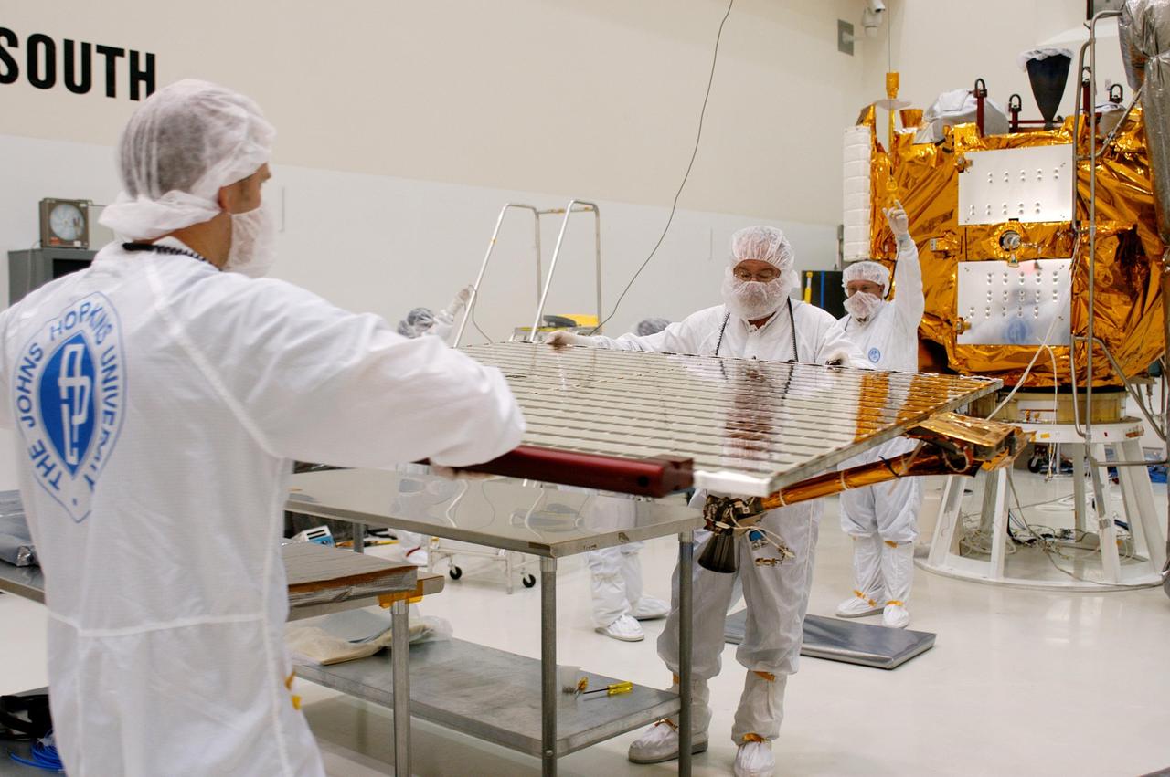 KENNEDY SPACE CENTER, FLA.  - At Astrotech in Titusville, Fla., technicians maneuver a second solar panel to a vertical position to move it toward NASA’s MESSENGER spacecraft for installation.  The two large solar panels, supplemented with a nickel-hydrogen battery, will provide MESSENGER’s power.  MESSENGER is scheduled to launch Aug. 2 aboard a Boeing Delta II rocket from Pad 17-B, Cape Canaveral Air Force Station, Fla. It will return to Earth for a gravity boost in July 2005, then fly past Venus twice, in October 2006 and June 2007. The spacecraft uses the tug of Venus’ gravity to resize and rotate its trajectory closer to Mercury’s orbit.  Three Mercury flybys, each followed about two months later by a course-correction maneuver, put MESSENGER in position to enter Mercury orbit in March 2011. During the flybys, MESSENGER will map nearly the entire planet in color, image most of the areas unseen by Mariner 10, and measure the composition of the surface, atmosphere and magnetosphere. It will be the first new data from Mercury in more than 30 years - and invaluable for planning MESSENGER’s year-long orbital mission.  MESSENGER was built for NASA by the Johns Hopkins University Applied Physics Laboratory in Laurel, Md.