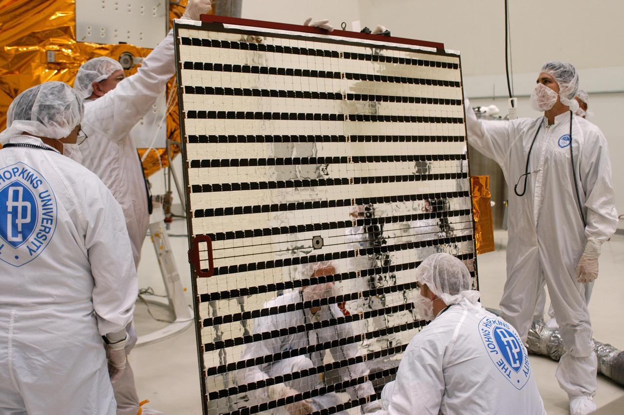 KENNEDY SPACE CENTER, FLA.  - At Astrotech in Titusville, Fla., technicians check the second solar panel that will be installed on NASA’s MESSENGER spacecraft.  The two large solar panels, supplemented with a nickel-hydrogen battery, will provide MESSENGER’s power.  MESSENGER is scheduled to launch Aug. 2 aboard a Boeing Delta II rocket from Pad 17-B, Cape Canaveral Air Force Station, Fla. It will return to Earth for a gravity boost in July 2005, then fly past Venus twice, in October 2006 and June 2007. The spacecraft uses the tug of Venus’ gravity to resize and rotate its trajectory closer to Mercury’s orbit.  Three Mercury flybys, each followed about two months later by a course-correction maneuver, put MESSENGER in position to enter Mercury orbit in March 2011. During the flybys, MESSENGER will map nearly the entire planet in color, image most of the areas unseen by Mariner 10, and measure the composition of the surface, atmosphere and magnetosphere. It will be the first new data from Mercury in more than 30 years - and invaluable for planning MESSENGER’s year-long orbital mission.  MESSENGER was built for NASA by the Johns Hopkins University Applied Physics Laboratory in Laurel, Md.