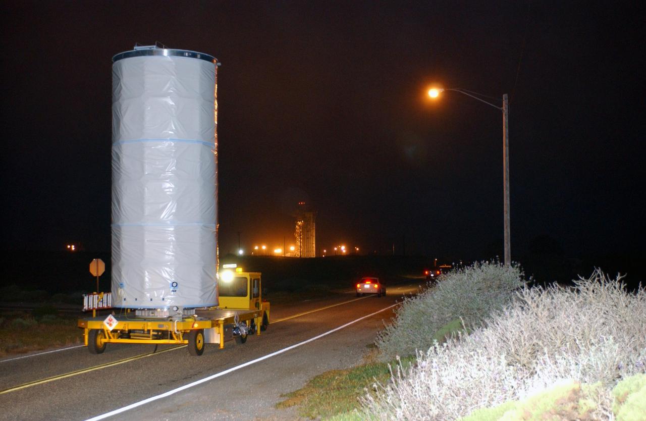 KENNEDY SPACE CENTER, FLA.  - In the predawn hours, the Aura spacecraft is transported the short distance from the Astrotech payload processing facility to Space Launch Complex 2 on North Vandenberg Air Force Base, Calif.  The latest in the Earth Observing System (EOS) series, Aura is scheduled to launch July 10 aboard a Boeing Delta II rocket.  Aura’s four state-of-the-art instruments will study the dynamics of chemistry occurring in the atmosphere.  The spacecraft will provide data to help scientists better understand the Earth’s ozone, air quality and climate change.