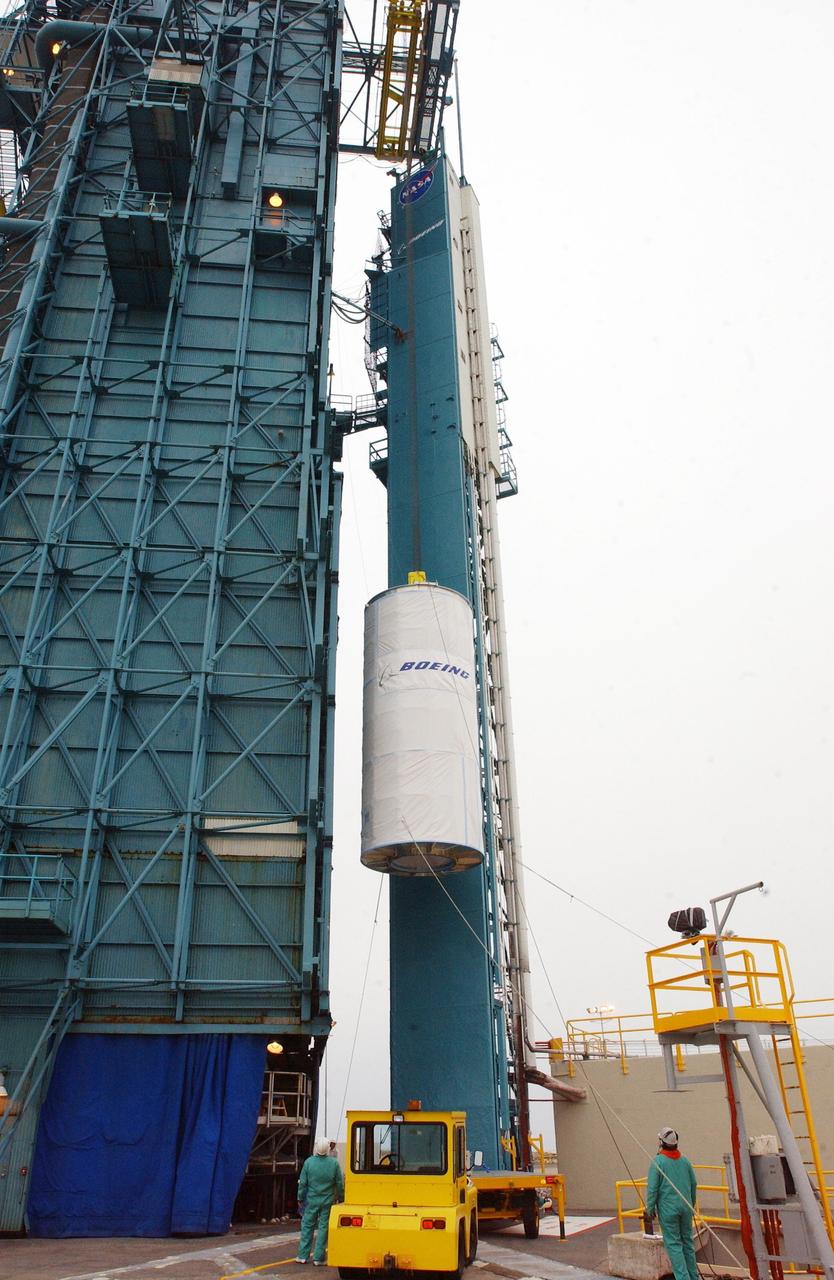 KENNEDY SPACE CENTER, FLA.  - At Space Launch Complex 2 on North Vandenberg Air Force Base, Calif., the Aura spacecraft is lifted up the mobile service tower, or gantry.  The latest in the Earth Observing System (EOS) series, Aura is scheduled to launch July 10 aboard the Boeing Delta II rocket.  Aura’s four state-of-the-art instruments will study the dynamics of chemistry occurring in the atmosphere.  The spacecraft will provide data to help scientists better understand the Earth’s ozone, air quality and climate change.