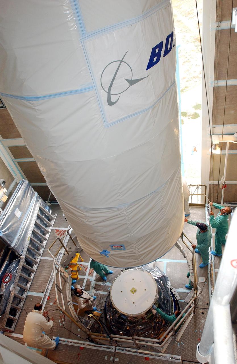 KENNEDY SPACE CENTER, FLA.  - Inside the mobile service tower, or gantry, at Space Launch Complex 2 on North Vandenberg Air Force Base, Calif., the Aura spacecraft is maneuvered into position over the second stage of the Boeing Delta II rocket.  After it is mated with the second stage, the fairing will be installed.  The latest in the Earth Observing System (EOS) series, Aura is scheduled to launch July 10.  Aura’s four state-of-the-art instruments will study the dynamics of chemistry occurring in the atmosphere.  The spacecraft will provide data to help scientists better understand the Earth’s ozone, air quality and climate change.