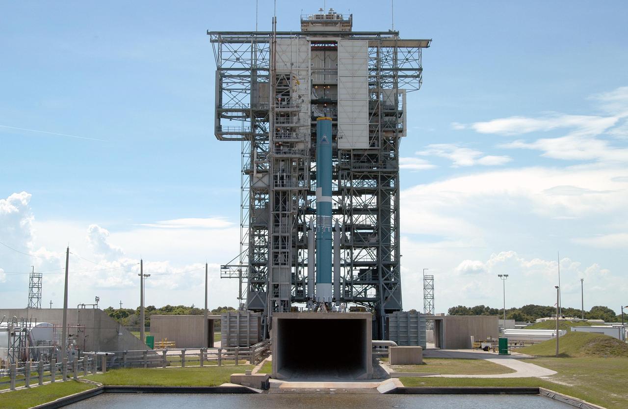 KENNEDY SPACE CENTER, FLA. -  On Pad 17-B, Cape Canaveral Air Force Station, the mobile service tower delivers the first three Solid Rocket Boosters (SRBs) to the Boeing Delta II Heavy rocket for mating.  In the foreground is the cooling water pond.  The Delta II is the launch vehicle for the Aug. 2 launch of the MESSENGER spacecraft to the planet Mercury.  The spacecraft is expected to reach orbit around Mercury in March 2011.  MESSENGER was built for NASA by the Johns Hopkins University Applied Physics Laboratory in Laurel, Md.