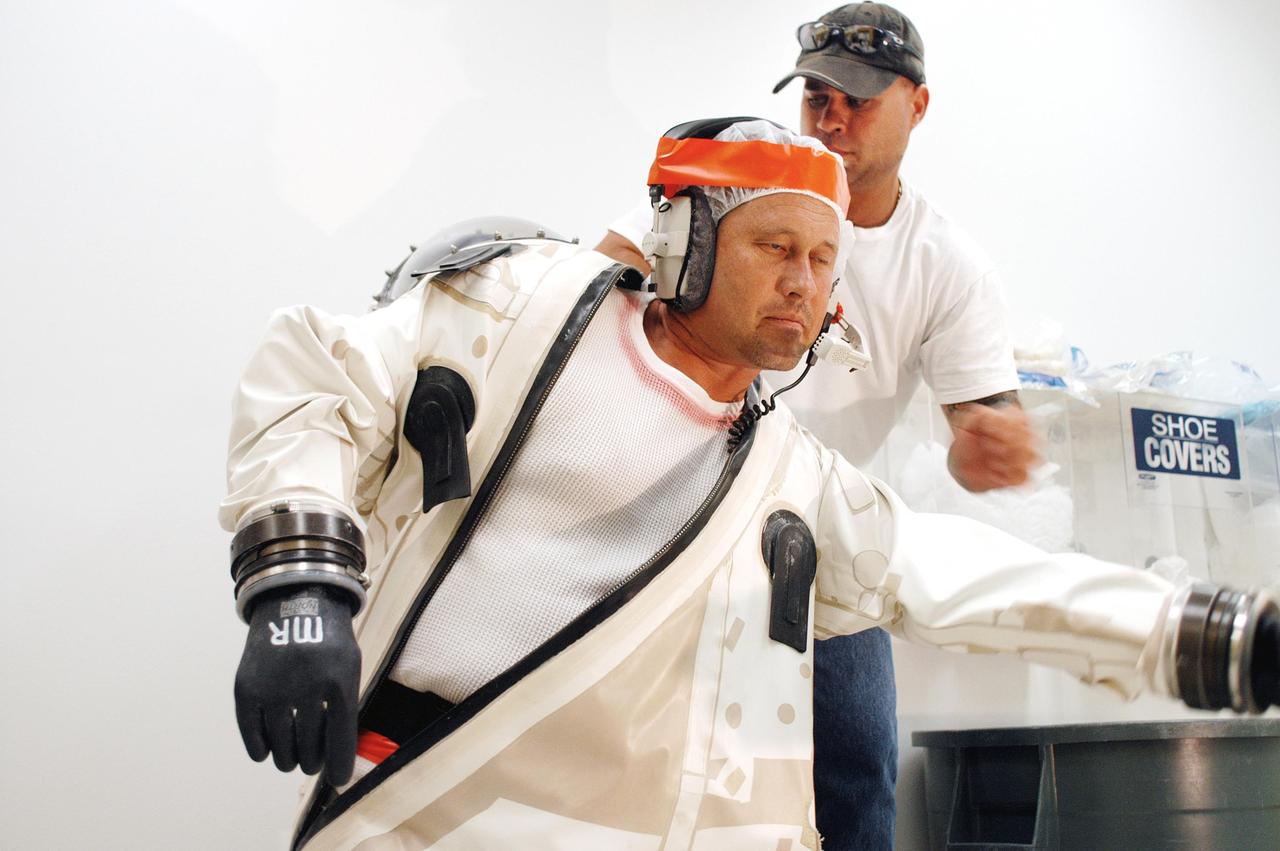 KENNEDY SPACE CENTER, FLA. -  A worker at Astrotech Space Operations in Titusville, Fla., suits up for spacecraft propellant loading of the MESSENGER (Mercury Surface, Space Environment, Geochemistry and Ranging) spacecraft.  Liftoff of MESSENGER aboard a Boeing Delta II Heavy rocket, bound for Mercury, is scheduled for Aug. 2.  The spacecraft is expected to reach orbit around the planet in March 2011.  MESSENGER was built for NASA by the Johns Hopkins University Applied Physics Laboratory in Laurel, Md.