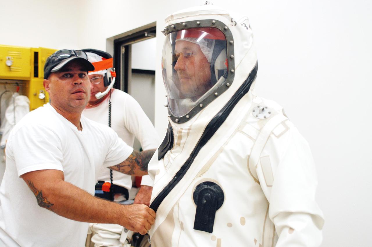 KENNEDY SPACE CENTER, FLA. - Workers at Astrotech Space Operations in Titusville, Fla., suit up for spacecraft propellant loading of the MESSENGER (Mercury Surface, Space Environment, Geochemistry and Ranging) spacecraft.  Liftoff of MESSENGER aboard a Boeing Delta II Heavy rocket, bound for Mercury, is scheduled for Aug. 2.  The spacecraft is expected to reach orbit around the planet in March 2011.  MESSENGER was built for NASA by the Johns Hopkins University Applied Physics Laboratory in Laurel, Md.