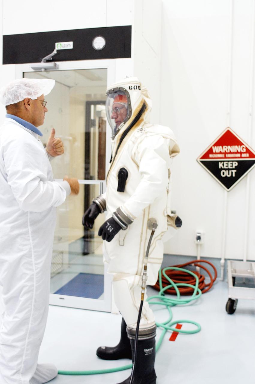 KENNEDY SPACE CENTER, FLA. - A worker (left) at Astrotech Space Operations in Titusville, Fla., questions another worker about the oxygen connection in his protective suit before spacecraft propellant loading of the MESSENGER (Mercury Surface, Space Environment, Geochemistry and Ranging) spacecraft.  Liftoff of MESSENGER aboard a Boeing Delta II Heavy rocket, bound for Mercury, is scheduled for Aug. 2.  The spacecraft is expected to reach orbit around the planet in March 2011.  MESSENGER was built for NASA by the Johns Hopkins University Applied Physics Laboratory in Laurel, Md.
