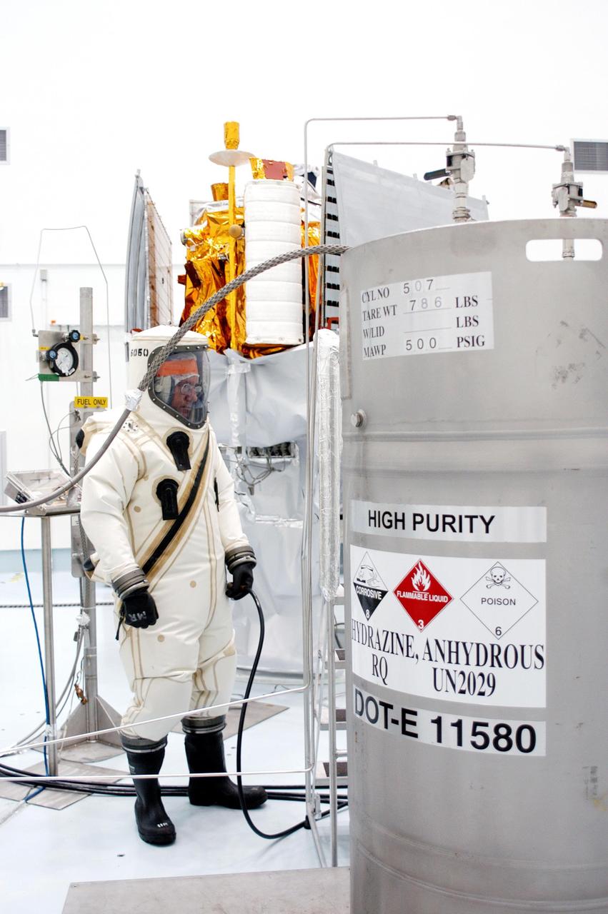 KENNEDY SPACE CENTER, FLA. - A suited worker at Astrotech Space Operations in Titusville, Fla., looks over the fuel supply to be loaded in the MESSENGER (Mercury Surface, Space Environment, Geochemistry and Ranging) spacecraft.  Liftoff of MESSENGER aboard a Boeing Delta II Heavy rocket, bound for Mercury, is scheduled for Aug. 2.  The spacecraft is expected to reach orbit around the planet in March 2011.  MESSENGER was built for NASA by the Johns Hopkins University Applied Physics Laboratory in Laurel, Md.