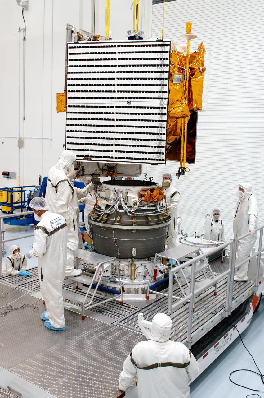 KENNEDY SPACE CENTER, FLA. - Technicians at Astrotech Space Operations in Titusville, Fla., oversee the mating of the MESSENGER spacecraft with the Payload Assist Module, the Boeing Delta II third stage, below it. MESSENGER (Mercury Surface, Space Environment, Geochemistry and Ranging) is scheduled to launch Aug. 2 aboard a Boeing Delta II rocket from Pad 17-B, Cape Canaveral Air Force Station, Fla. It will return to Earth for a gravity boost in July 2005, then fly past Venus twice, in October 2006 and June 2007. It is expected to enter Mercury orbit in March 2011. MESSENGER was built for NASA by the Johns Hopkins University Applied Physics Laboratory in Laurel, Md.