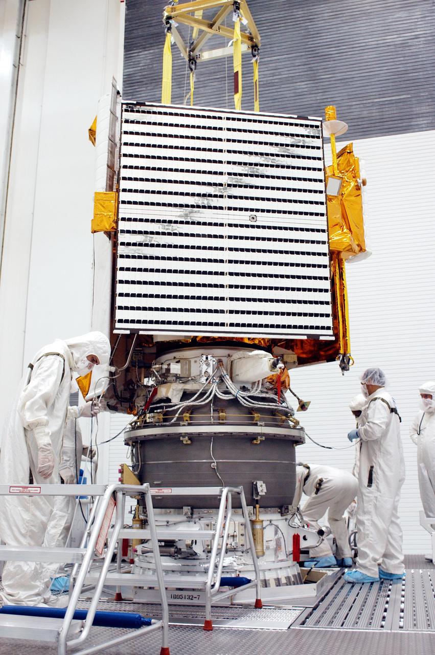 KENNEDY SPACE CENTER, FLA. - Technicians at Astrotech Space Operations in Titusville, Fla., complete the mating of the MESSENGER spacecraft with the Payload Assist Module, the Boeing Delta II third stage, below it. MESSENGER (Mercury Surface, Space Environment, Geochemistry and Ranging) is scheduled to launch Aug. 2 aboard a Boeing Delta II rocket from Pad 17-B, Cape Canaveral Air Force Station, Fla. It will return to Earth for a gravity boost in July 2005, then fly past Venus twice, in October 2006 and June 2007. It is expected to enter Mercury orbit in March 2011. MESSENGER was built for NASA by the Johns Hopkins University Applied Physics Laboratory in Laurel, Md.