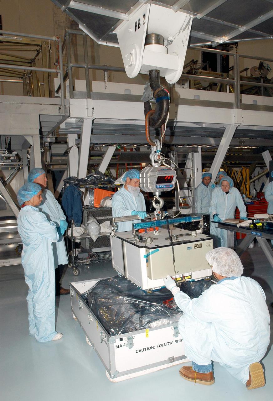 KENNEDY SPACE CENTER, FLA. - Technicians attach a crane to the Pump Flow Control Subsystem (PFCS) in the Space Station Processing Facility. The PFCS pumps and controls the liquid ammonia used to cool the various Orbital Replacement Units on the Integrated Equipment Assembly that make up the S6 Photo-Voltaic Power Module on the International Space Station (ISS). The fourth starboard truss segment, the S6 Truss measures 112 feet long by 39 feet wide. Its solar arrays are mounted on a “blanket” that can be folded like an accordion for delivery to the ISS. Once in orbit, astronauts will deploy the blankets to their full size. When completed, the Station's electrical power system (EPS) will use eight photovoltaic solar arrays to convert sunlight to electricity. Delivery of the S6 Truss, the last power module truss segment, is targeted for mission STS-119.