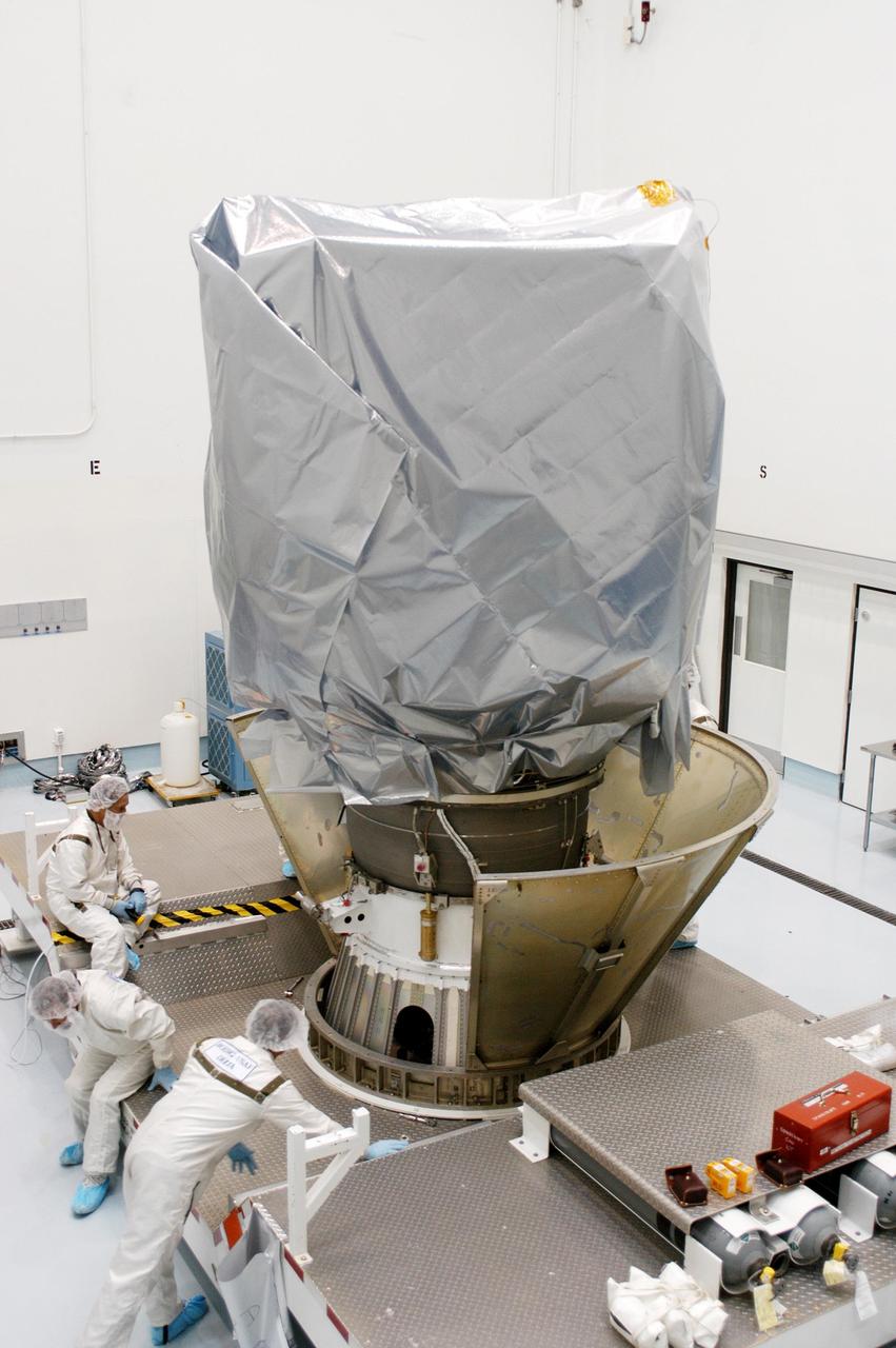 KENNEDY SPACE CENTER, FLA. - Boeing workers at Astrotech Space Operations in Titusville, Fla., check the second part of a transportation canister placed around the Delta II upper stage booster on the MESSENGER (Mercury Surface, Space Environment, Geochemistry and Ranging) spacecraft.  MESSENGER will be transported to Launch Pad 17-B at Cape Canaveral Air Force Station, Fla.  Liftoff of MESSENGER aboard a Boeing Delta II Heavy rocket is scheduled for Aug. 2.  The spacecraft is expected to reach orbit around the planet in March 2011.  MESSENGER was built for NASA by the Johns Hopkins University Applied Physics Laboratory in Laurel, Md.