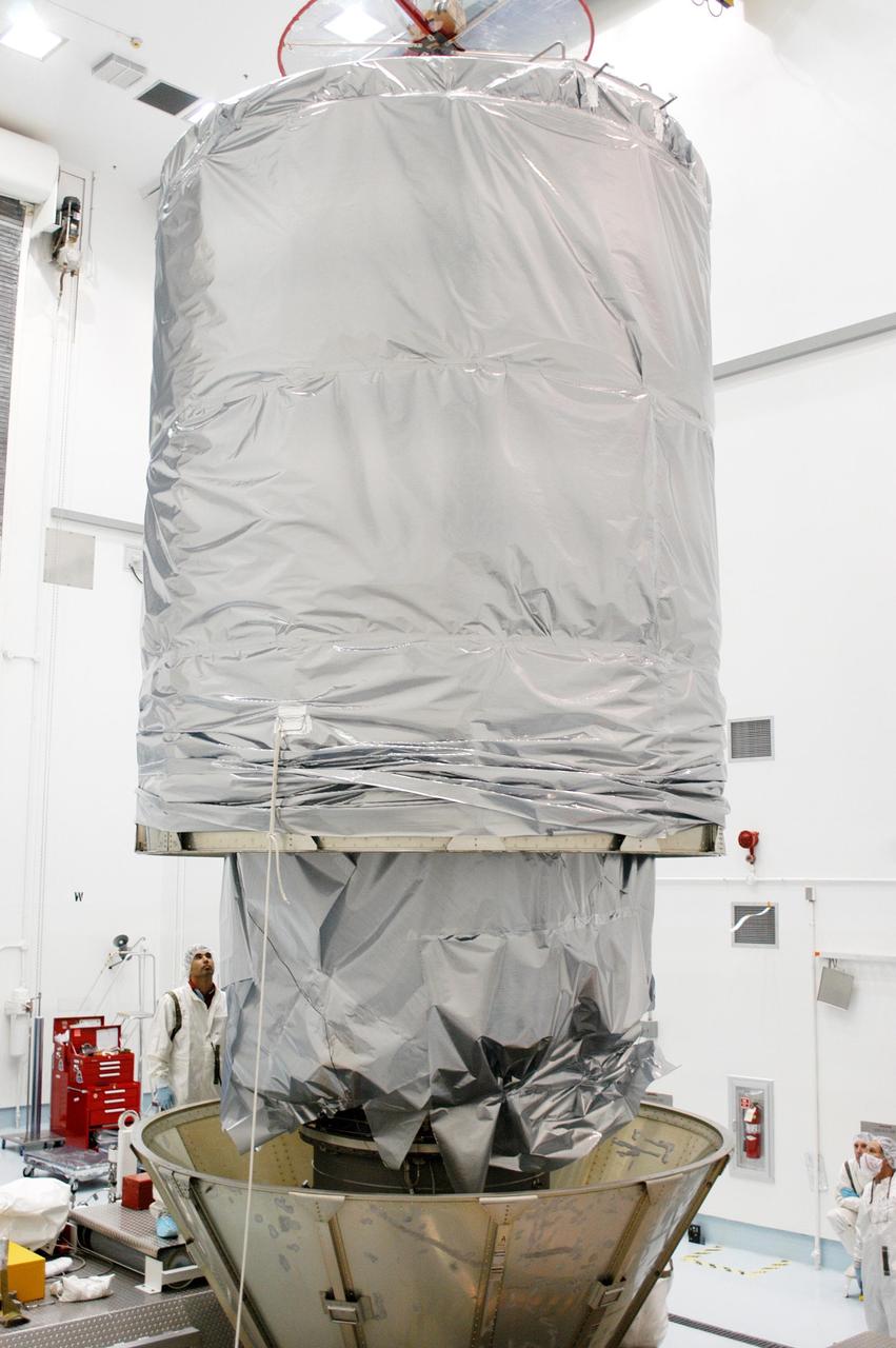 KENNEDY SPACE CENTER, FLA. - At Astrotech Space Operations in Titusville, Fla., the upper canister is lowered around the MESSENGER (Mercury Surface, Space Environment, Geochemistry and Ranging) spacecraft.  The canister will be attached to the lower protective panels around the Delta II  upper stage booster for the transportation of MESSENGER to Launch Pad 17-B at Cape Canaveral Air Force Station, Fla.  Liftoff of MESSENGER aboard a Boeing Delta II Heavy rocket is scheduled for Aug. 2.  The spacecraft is expected to reach orbit around the planet in March 2011.  MESSENGER was built for NASA by the Johns Hopkins University Applied Physics Laboratory in Laurel, Md.