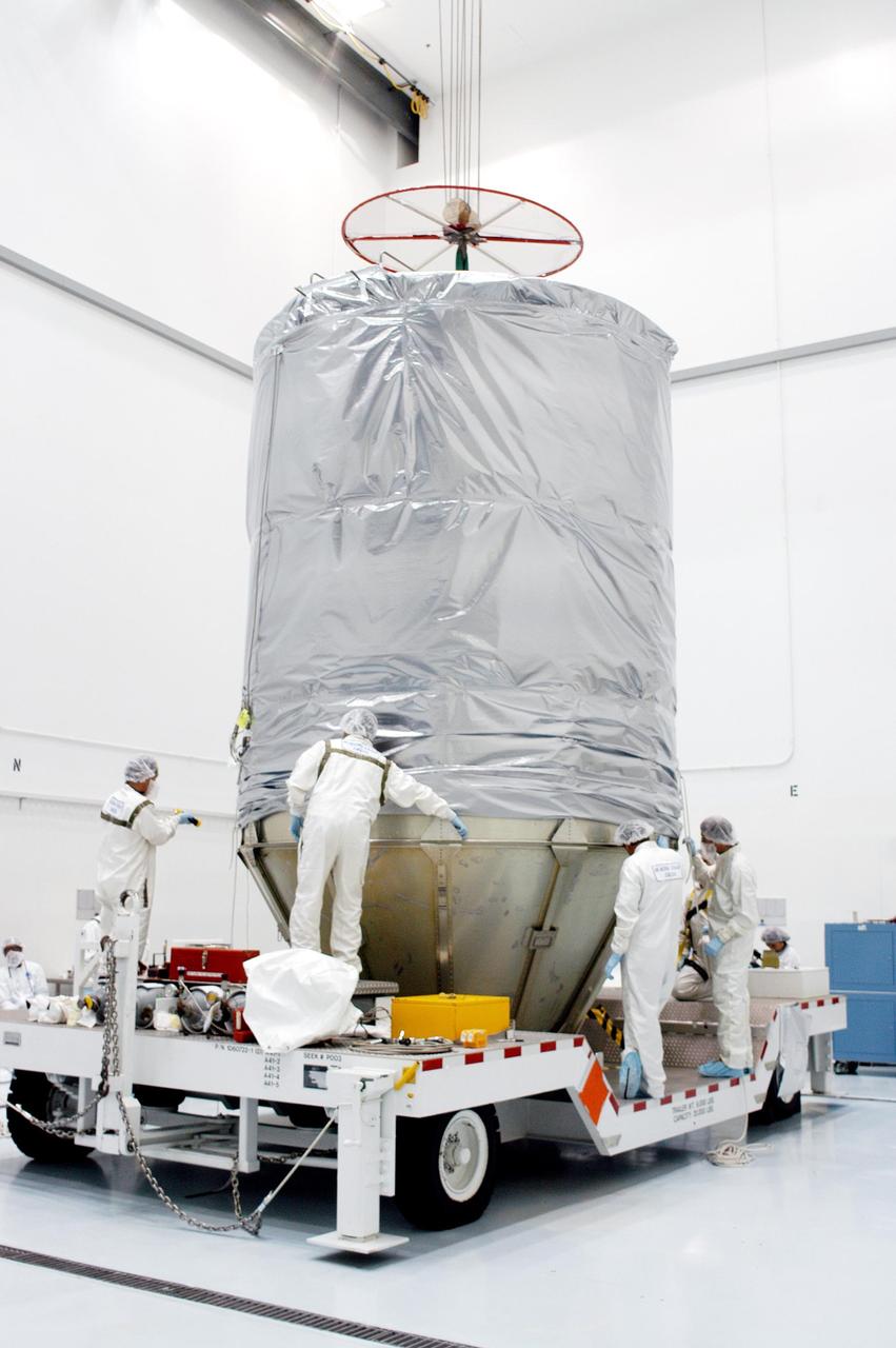 KENNEDY SPACE CENTER, FLA. - At Astrotech Space Operations in Titusville, Fla., Boeing workers make final adjustments to the mating of the upper canister around the MESSENGER (Mercury Surface, Space Environment, Geochemistry and Ranging) spacecraft with the lower protective panels around the Delta II  upper stage booster for the transportation of MESSENGER to Launch Pad 17-B at Cape Canaveral Air Force Station, Fla.  Liftoff of MESSENGER aboard a Boeing Delta II Heavy rocket is scheduled for Aug. 2.  The spacecraft is expected to reach orbit around the planet in March 2011.  MESSENGER was built for NASA by the Johns Hopkins University Applied Physics Laboratory in Laurel, Md.