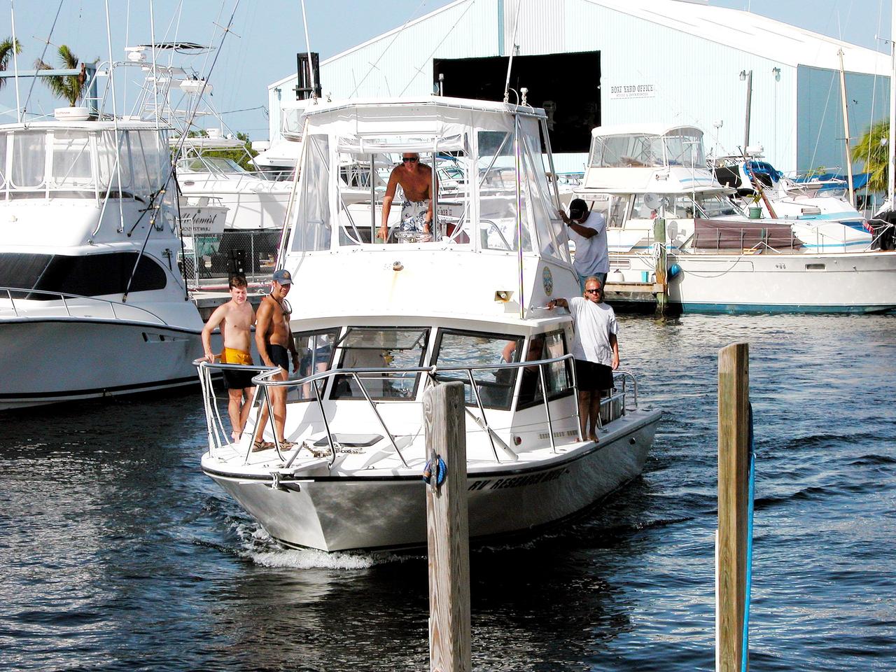 KENNEDY SPACE CENTER, FLA. - A boat returns to the dock in Key Largo from a training session offshore at NASA’s undersea research station, named Aquarius. At left is Marc Reagan, lead on the NASA Extreme Environment Mission Operations 6 (NEEMO-6) mission. In the bow is astronaut John Herrington, mission commander. The others are support personnel. Members of the team also include astronauts Doug Wheelock and Nick Patrick, and biomedical engineer Tara Ruttley. To prepare for their 10-day stay, the team had dive training twice a day. While stationed in Aquarius, the team conducted spacewalk-like diving excursions and field-testing a variety of biomedical equipment designed to help astronauts living aboard the International Space Station.