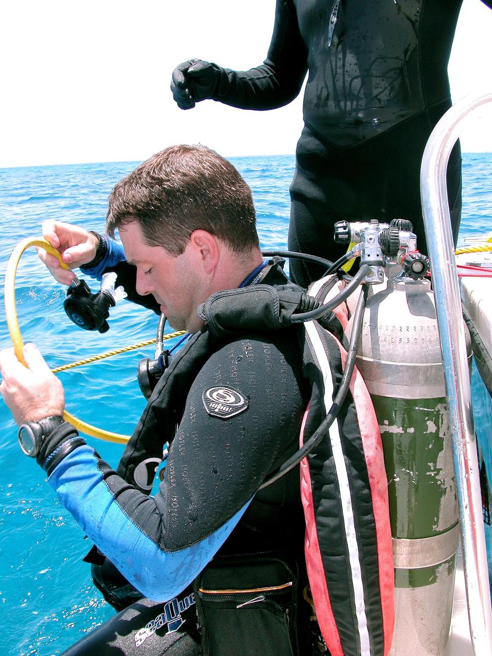 KENNEDY SPACE CENTER, FLA. - Getting ready to enter the water on a practice dive in the ocean offshore from Key Largo is Nick Patrick. He is a member of the NASA Extreme Environment Mission Operations 6 (NEEMO-6) mission team. The others are astronauts John Herrington, mission commander, and Doug Wheelock, plus Tara Ruttley, a biomedical engineer.  The NEEMO-6 mission involves exposing an astronaut/scientist crew to a real mission experience in an extreme environment - the NOAA undersea station Aquarius - to prepare for future space flight.  Spacewalk-like diving excursions and field-tests on a variety of biomedical equipment are designed to help astronauts living aboard the International Space Station.  To prepare for their 10-day stay, the team had dive training twice a day at the Life Support Buoy, anchored above Aquarius.