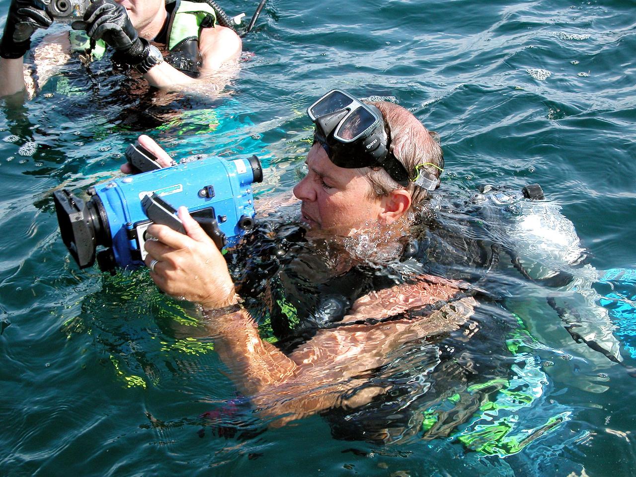 KENNEDY SPACE CENTER, FLA. - In the water offshore from Key Largo, site of the NASA Extreme Environment Mission Operations 6 (NEEMO-6), are (left to right) Bill Todd, project lead, and Marc Reagan, mission lead.  Todd and Lucas are also the underwater videographer and still photographer, respectively, for the mission.  The NEEMO-6 team comprises John Herrington, commander, Tara Ruttley, a biomedical engineer, and astronauts Nick Patrick and Doug Wheelock.  The NEEMO-6 mission involves exposing an astronaut/scientist crew to a real mission experience in an extreme environment - the NOAA undersea station Aquarius - to prepare for future space flight.  Spacewalk-like diving excursions and field-tests on a variety of biomedical equipment are designed to help astronauts living aboard the International Space Station.  To prepare for their 10-day stay, the team had dive training twice a day at the Life Support Buoy, anchored above Aquarius.