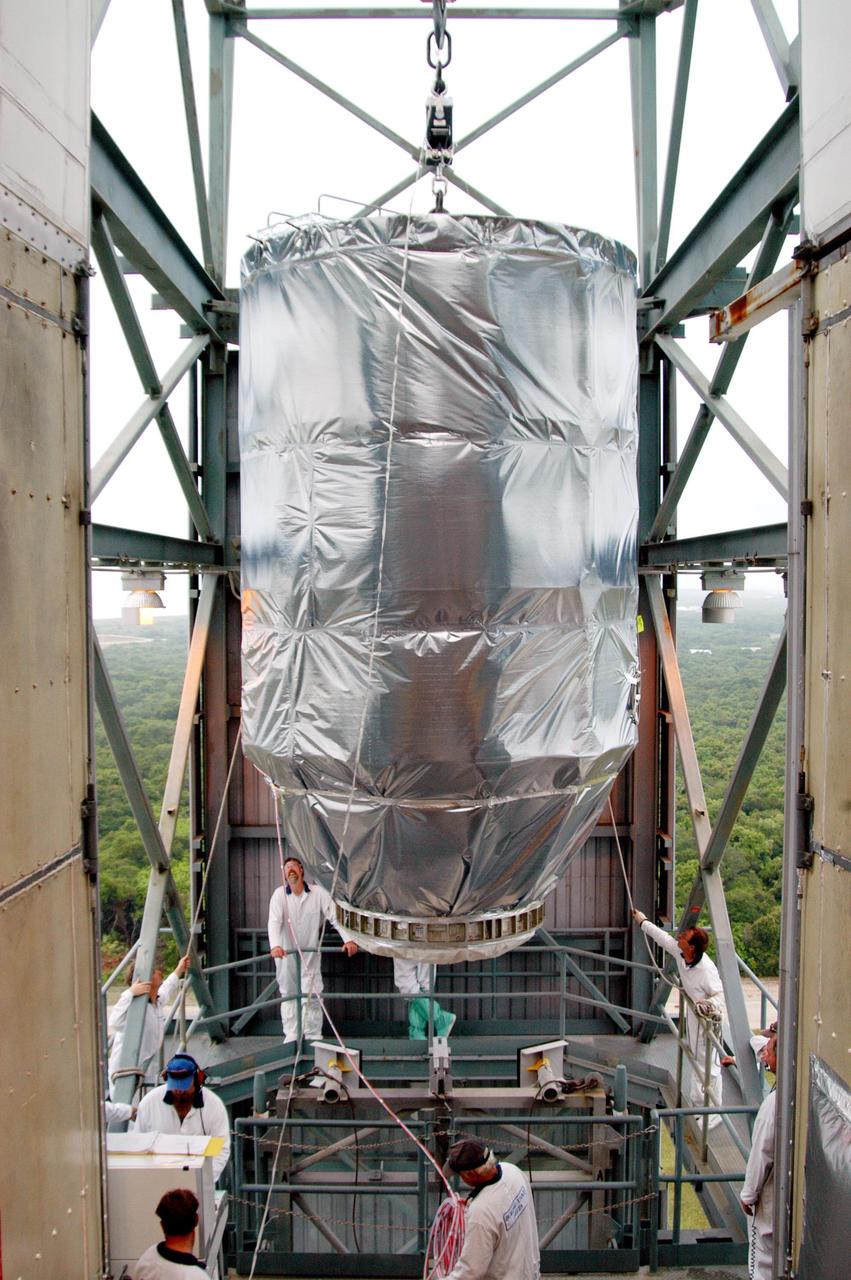 KENNEDY SPACE CENTER, FLA. -  Workers in the mobile service tower on Launch Pad 17-B at Cape Canaveral Air Force Station keep watch as the MESSENGER spacecraft is moved inside.  The spacecraft will be mated to the Boeing Delta II Heavy rocket.  Liftoff is scheduled for Aug. 2.  The spacecraft is expected to reach orbit around the planet in March 2011.  MESSENGER was built for NASA by the Johns Hopkins University Applied Physics Laboratory in Laurel, Md.
