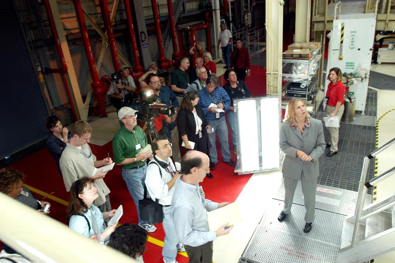 KENNEDY SPACE CENTER, FLA. -   Stephanie Stilson (second from right), NASA Vehicle Manager, briefs the media attending an informative workshop and tour of the Orbiter Processing Facility (OPF) housing the Space Shuttle Discovery at KSC. During this event, the media received the latest information on Discovery’s processing and viewed workers preparing the vehicle for its safe return to flight scheduled for a launch planning window of March 2005.  Kicking off the activities at the Press Site Auditorium, technical experts led two workshops addressing Reinforced Carbon-Carbon and vehicle instrumentation.  During the tour of the OPF, reporters saw work in progress on Discovery, including reinstallation of the Reinforced Carbon-Carbon panels on the Shuttle's wing leading edge, wiring inspections and instrumentation updates being completed for Return to Flight.