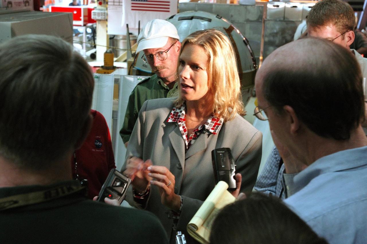 KENNEDY SPACE CENTER, FLA. -   Stephanie Stilson (center), NASA Vehicle Manager, briefs the media attending an informative workshop and tour of the Orbiter Processing Facility (OPF) housing the Space Shuttle Discovery at KSC. During this event, the media received the latest information on Discovery’s processing and viewed workers preparing the vehicle for its safe return to flight scheduled for a launch planning window of March 2005.  Kicking off the activities at the Press Site Auditorium, technical experts led two workshops addressing Reinforced Carbon-Carbon and vehicle instrumentation.  During the tour of the OPF, reporters saw work in progress on Discovery, including reinstallation of the Reinforced Carbon-Carbon panels on the Shuttle's wing leading edge, wiring inspections and instrumentation updates being completed for Return to Flight.