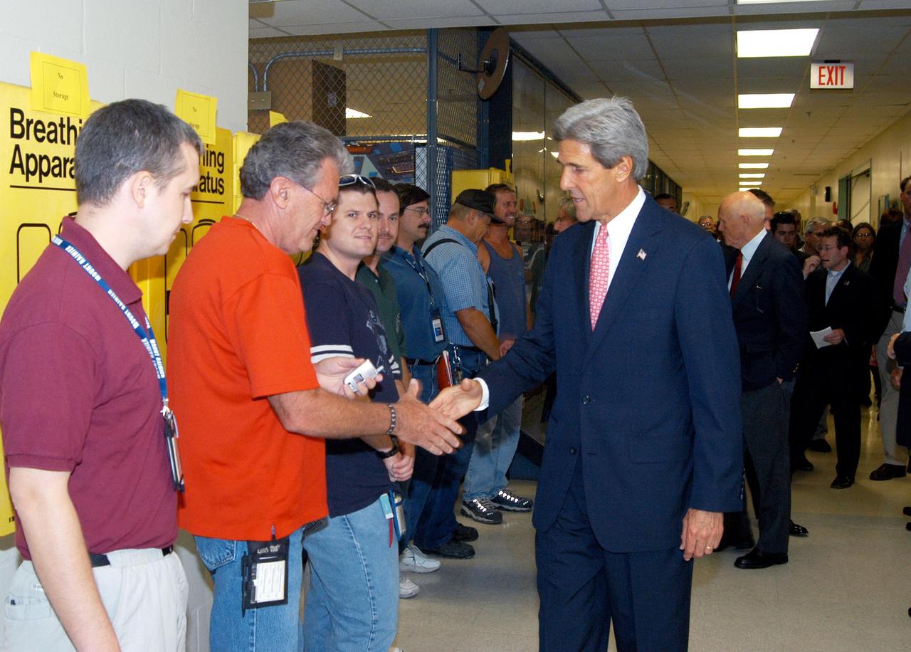 KENNEDY SPACE CENTER, FLA. - Sen. John F. Kerry, D-Mass., greets Kennedy Space Center employees during a tour of the Orbiter Processing Facility (OPF). The orbiter Discovery is being prepared for flight in the OPF on the next Space Shuttle mission. The tour follows a public meeting Kerry held at the Dr. Kurt H. Debus Conference Facility at the Kennedy Space Center Visitor Complex. He said he chose to speak at KSC because it symbolizes America’s commitment to science, innovation and technology. He and Sen. John Edwards, D-N.C., are on a speaking tour prior to their appearance at the Democratic National Convention in Boston.