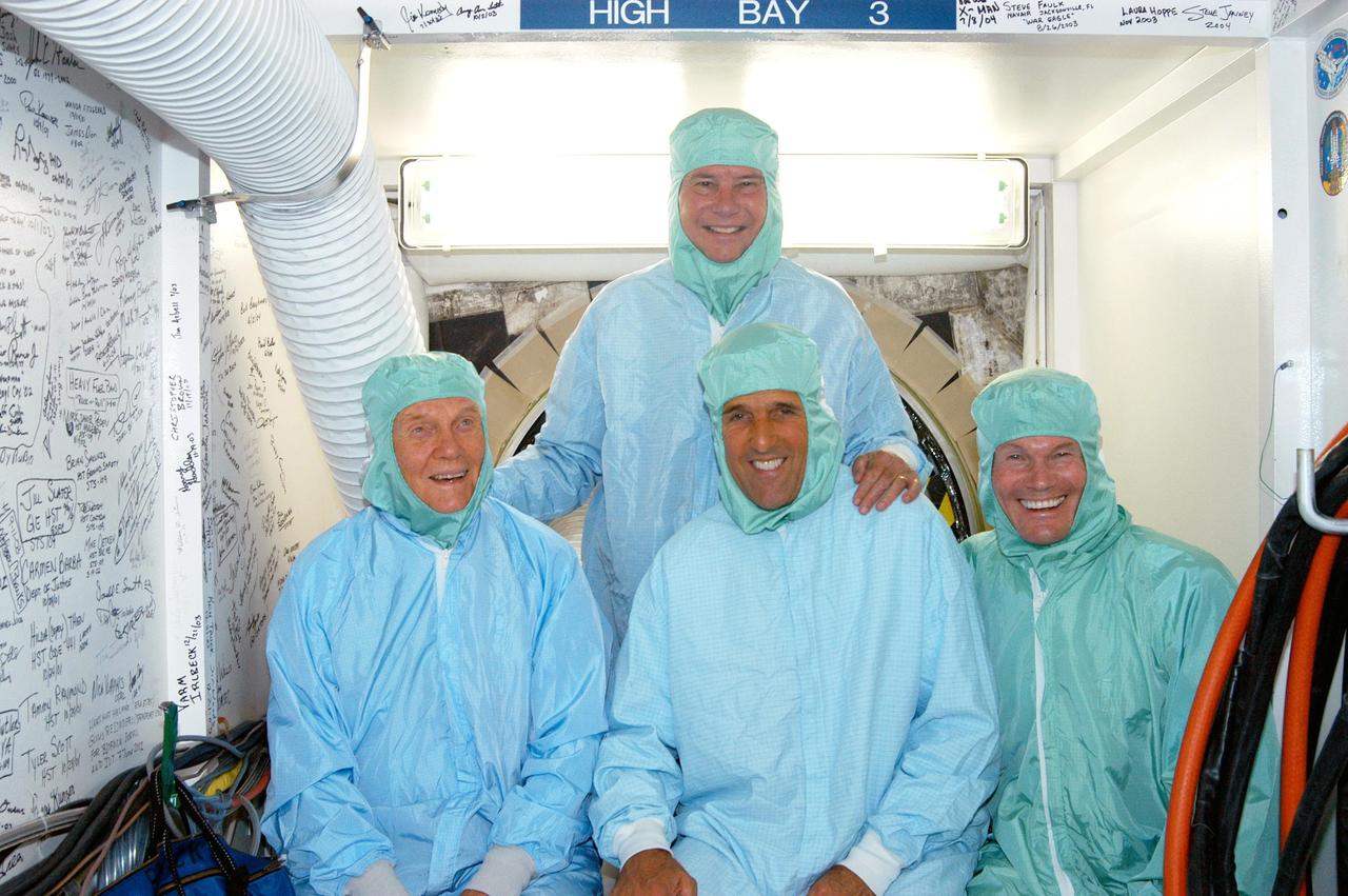 KENNEDY SPACE CENTER, FLA. - Sen. Bob Graham (back), D-Fla., former astronaut and Sen. John H. Glenn (front left), D-Ohio,  Sen. John F. Kerry, D-Mass., and Sen. Bill Nelson, D-Fla., don clean room attire during a tour of the Orbiter Processing Facility (OPF). The “bunny suits” are required dress for anyone coming in close proximity to the orbiter Discovery, currently being prepared for flight on the next Space Shuttle mission. The tour of the OPF follows a public meeting Kerry held at the Dr. Kurt H. Debus Conference Facility at the Kennedy Space Center Visitor Complex.  He said he chose to speak at KSC because it symbolizes America’s commitment to science, innovation and technology. He and Sen. John Edwards, D-N.C., are on a speaking tour prior to their appearance at the Democratic National Convention in Boston.
