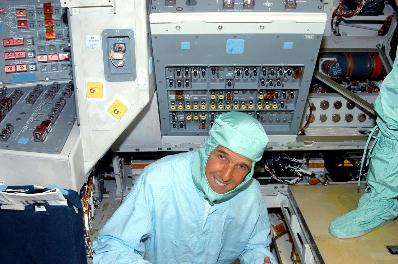 KENNEDY SPACE CENTER, FLA. - Sen. John F. Kerry, D-Mass., visits the flight deck of Space Shuttle Discovery during a tour of the Orbiter Processing Facility (OPF). The “bunny suit” he is wearing is clean room attire required for anyone coming in close proximity to Discovery, currently being prepared for flight on the next Space Shuttle mission. The tour of the OPF follows a public meeting Kerry held at the Dr. Kurt H. Debus Conference Facility at the Kennedy Space Center Visitor Complex.  He said he chose to speak at KSC because it symbolizes America’s commitment to science, innovation and technology. He and Sen. John Edwards, D-N.C., are on a speaking tour prior to their appearance at the Democratic National Convention in Boston.